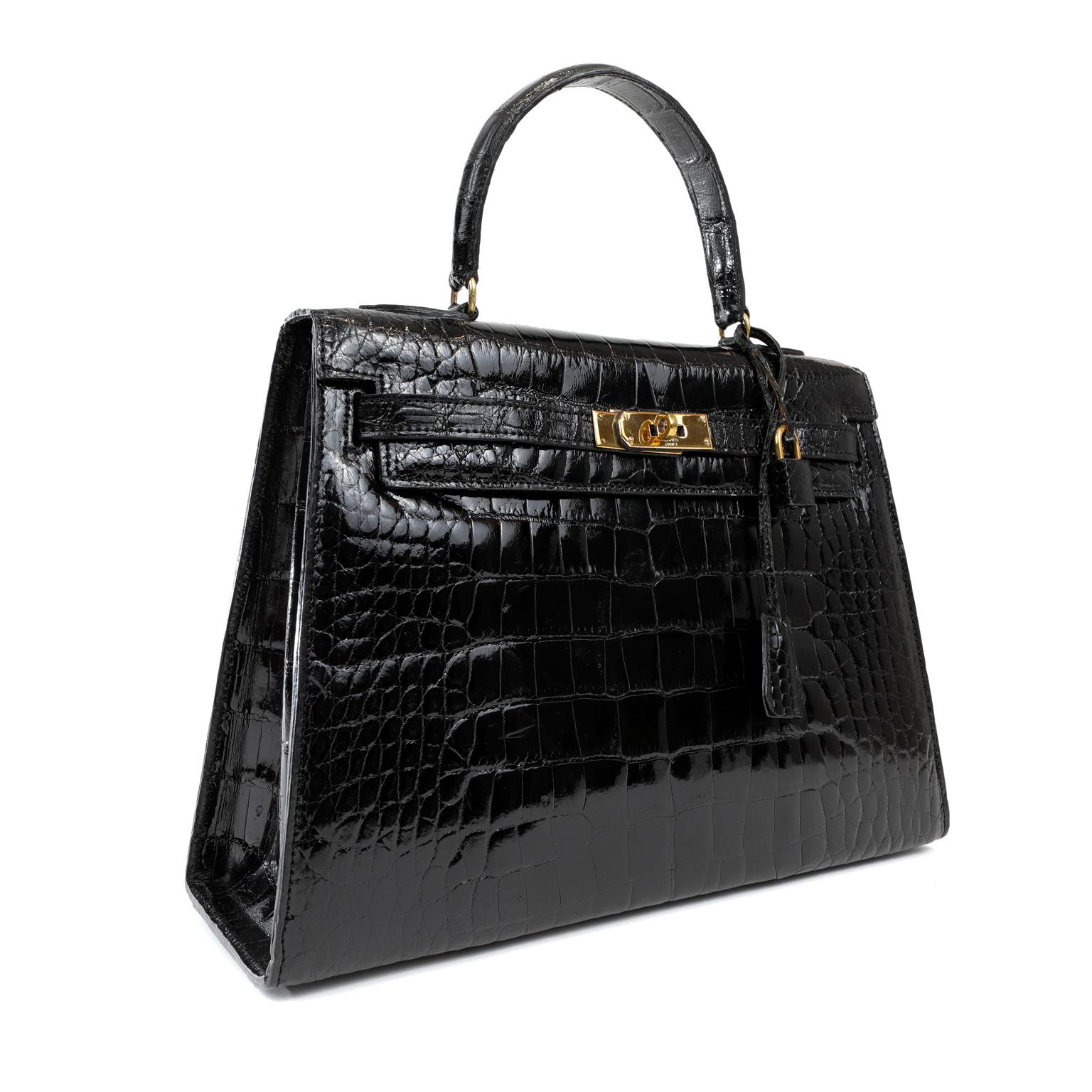 This authentic Hermès Black Crocodile 32 cm Sellier Kelly is in beautiful condition.  Hermès bags are considered the ultimate luxury item worldwide.  Each piece is hand sewn with waitlists that can exceed a year or more.  Black crocodile paired with