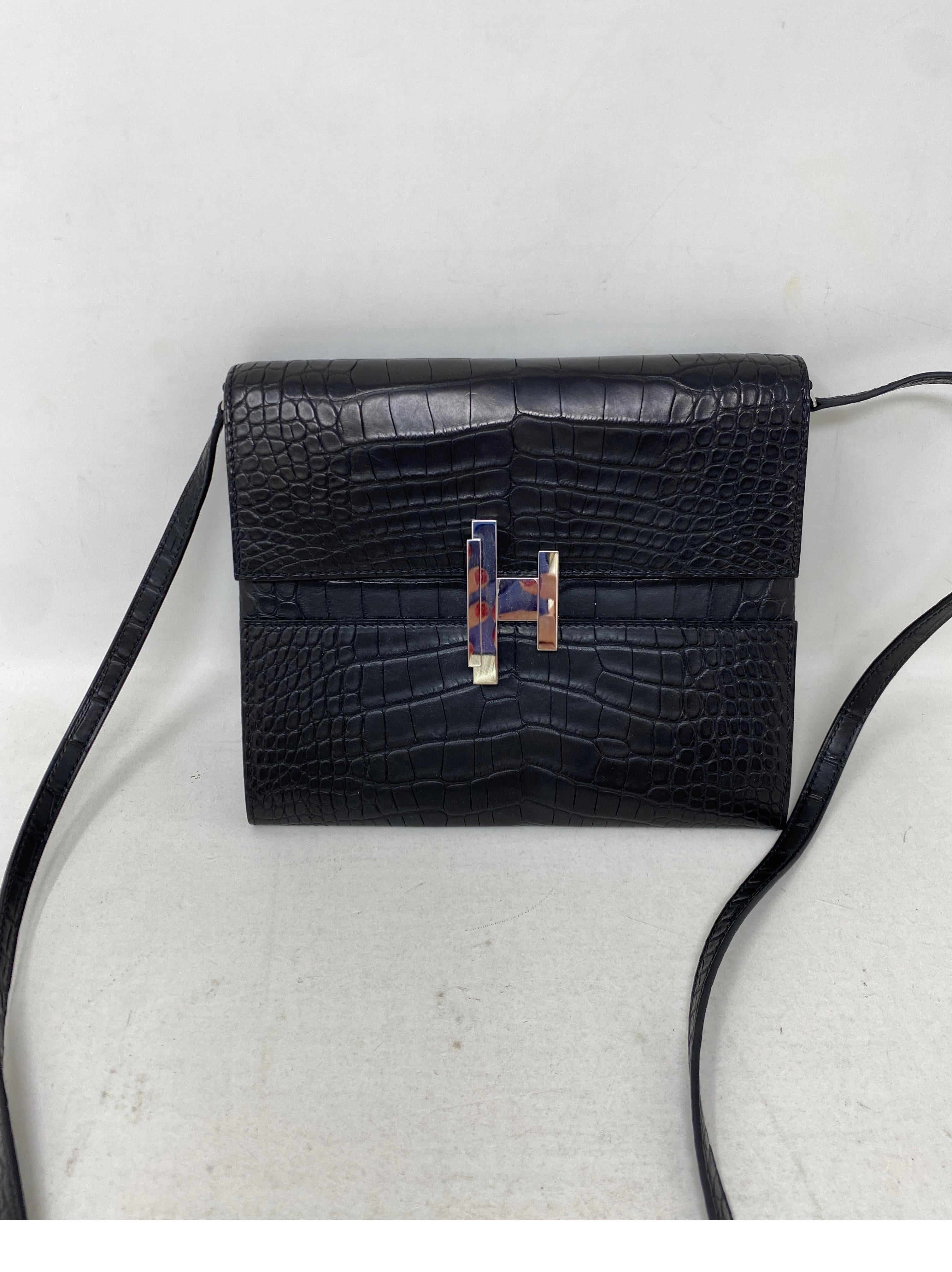 Hermes Black Crocodile Crossbody Bag. Rare and beautiful small crossbody bag from Hermes. Silver palladium hardware. Strap can be taken off and bag can be worn as a clutch. H closure twists to open. Excellent like new condition. Includes dust bag