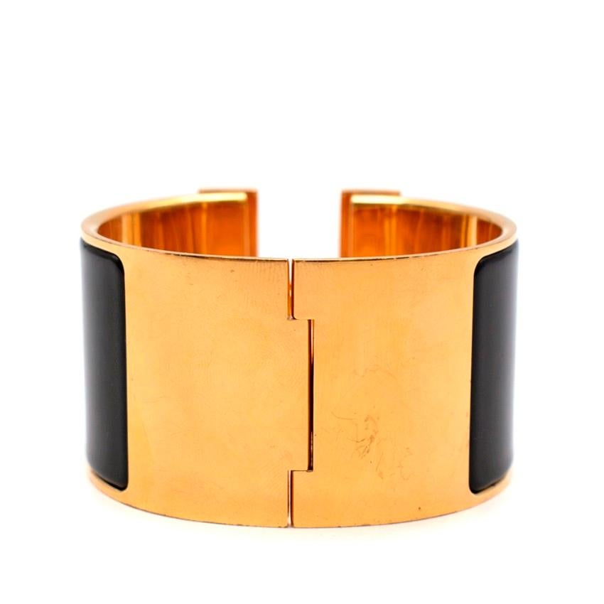 Hermes Black Enamel Extra Wide Clic Clac Bracelet GHW

- Age P 2012
- Black enamel 
- Gold plated hardware 
- Metal bangle
- Toggle clasp marked with an 