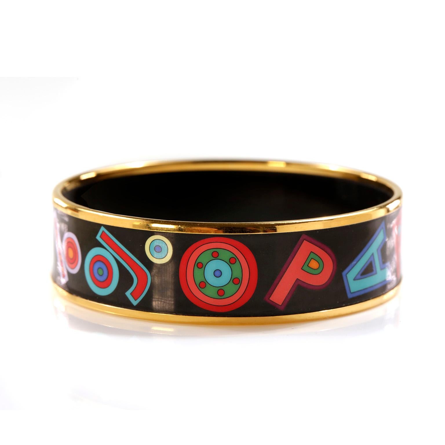 This authentic Hermès Black Enamel Tohu Bohu Bracelet is in excellent condition. 
Tohu Bohu (or Hurly Burly). Black background, gold plated edges and whimsical letter and number design depicts the abbreviation for the Hermès store address in Paris. 