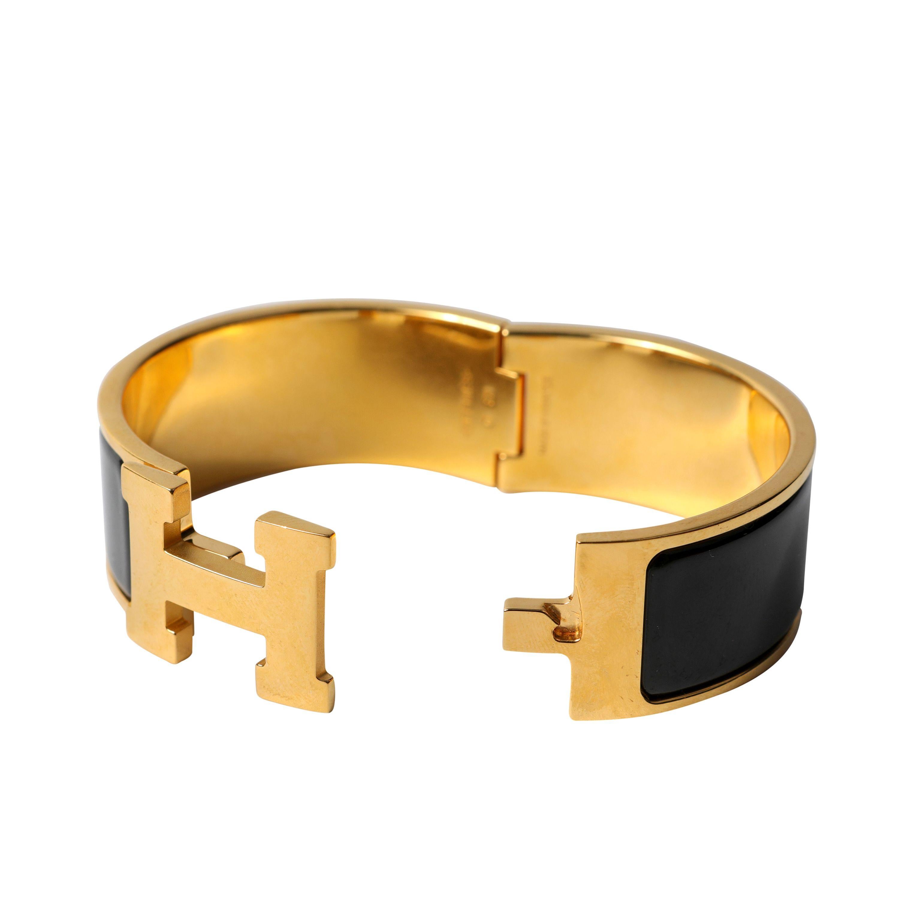 This authentic Hermès Black Wide Clic Clac Bracelet is in pristine condition.  Gold hardware with H swivel hinge.  Made in France.  Pouch or box included.

PBF 13645