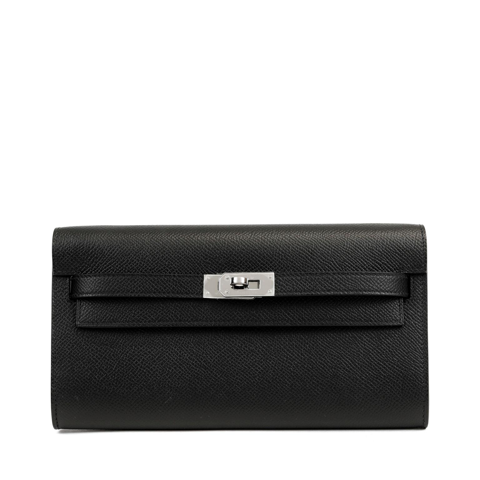 This authentic Hermès Black Epsom Kelly To Go Wallet is in pristine unworn condition with the protective plastic intact on the Palladium hardware.  Sleek, stylish and versatile, the To Go Wallet functions a cross body bag as well as a holder for