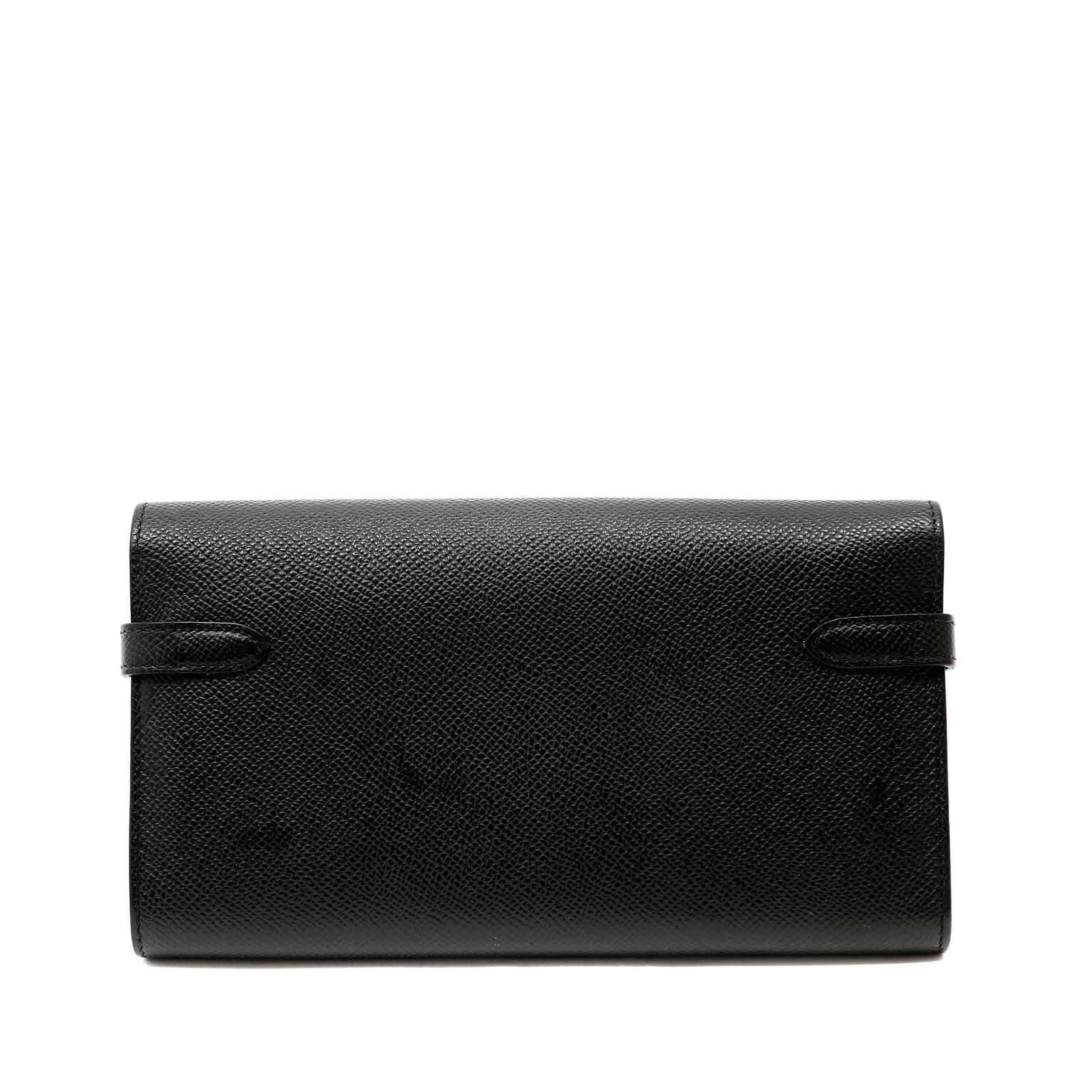 This authentic Hermès Black Epsom Kelly Wallet is in pristine unworn condition.  The perfect companion to organize cards, currency and coinage, the Classic Kelly Wallet is chic and functional.
Sleek black Epsom leather is textured and durable,