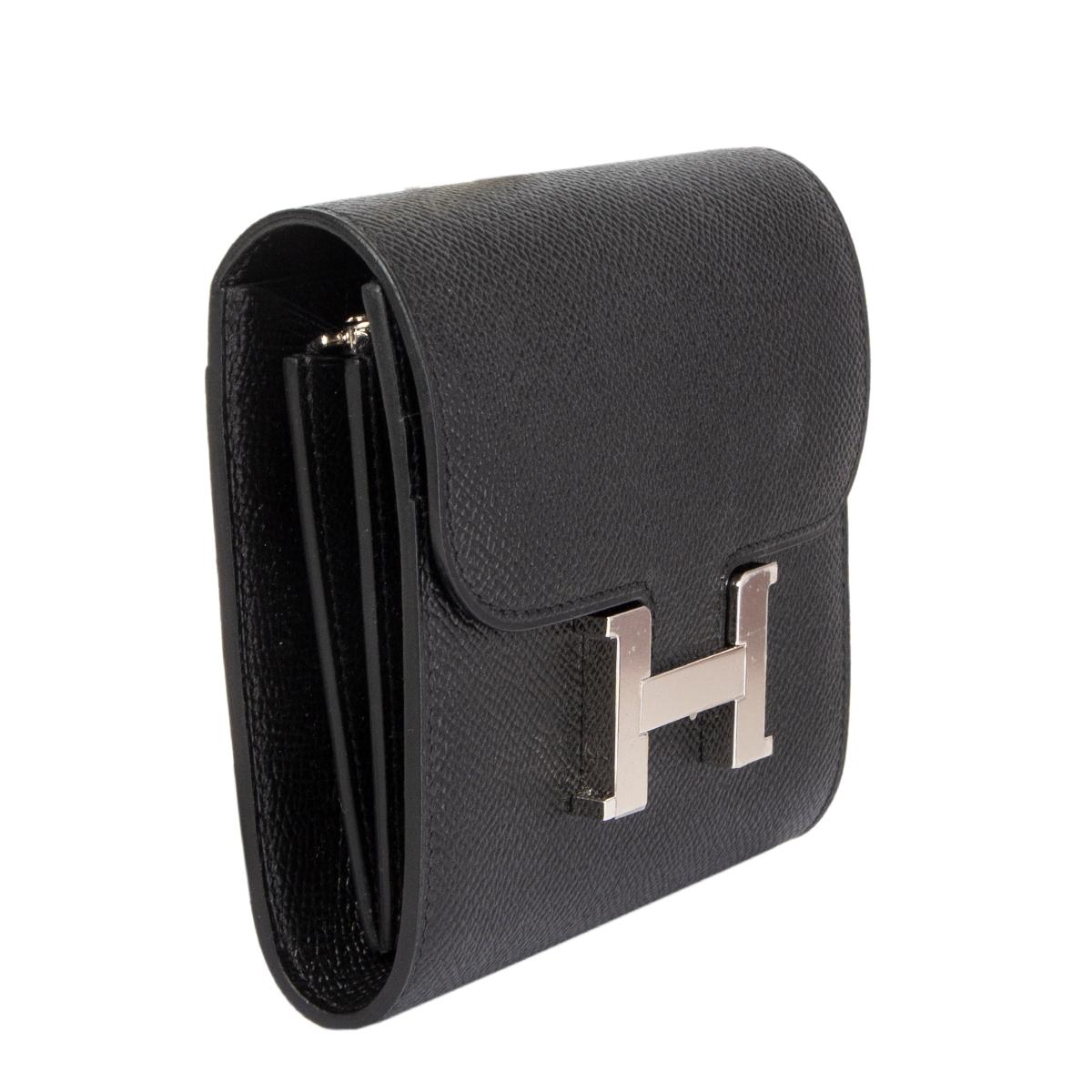 Hermes 'Constance Compact' wallet in Noir (black) Veau Epsom leather with Palladium H closure. Two credit card slots and a full-size pocket on the front under the flap. Lined in black Veau Swift with two credit card slots and a full-size pocket