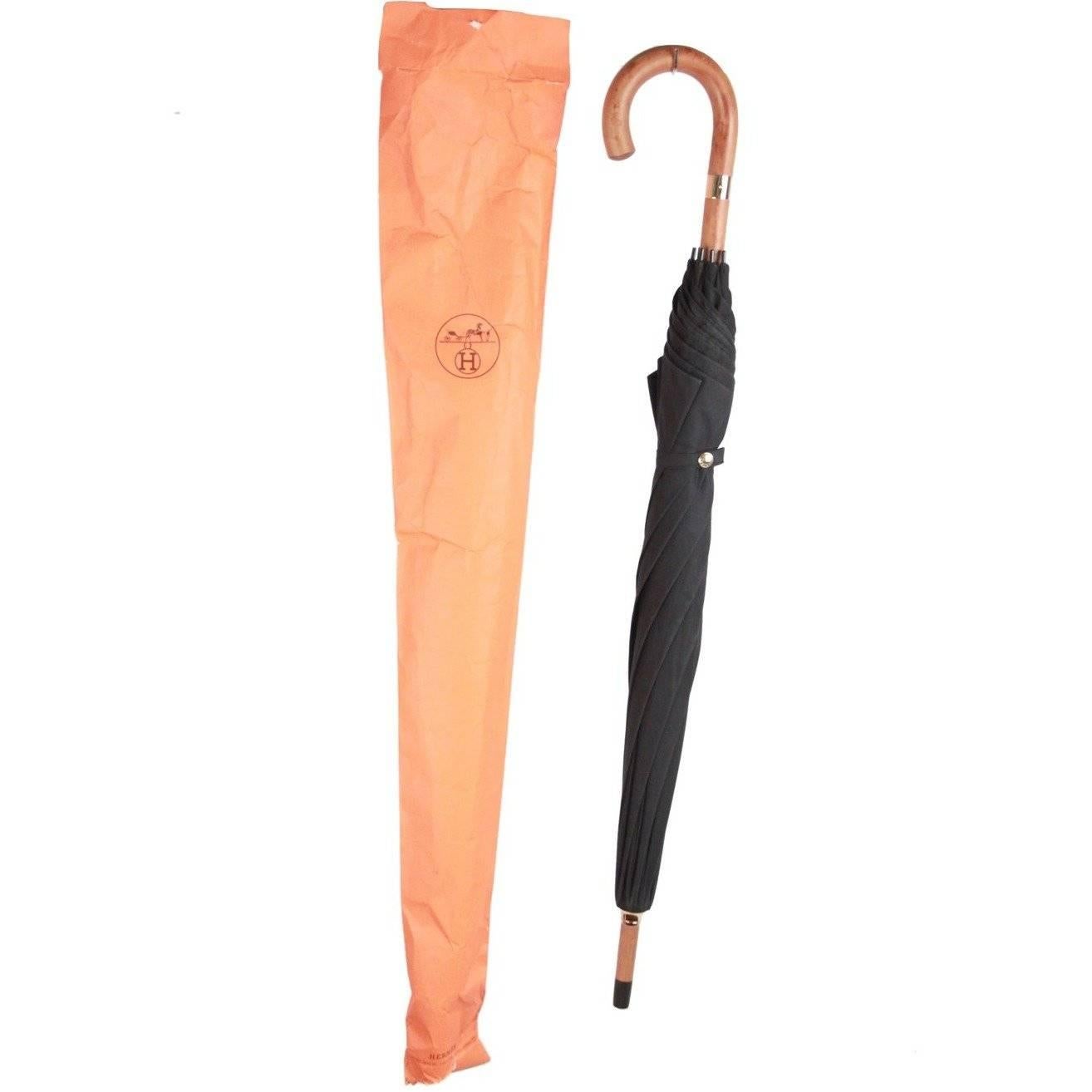 - HERMES cane umbrella - Black fabric - Light gold-metal hardware - Wood handle - Total lenght: 36 inches - 91,6 cm - Made in England Logos & Tags: 'HERMES Paris' embossed on the stick, HERMES tag, signed hardware