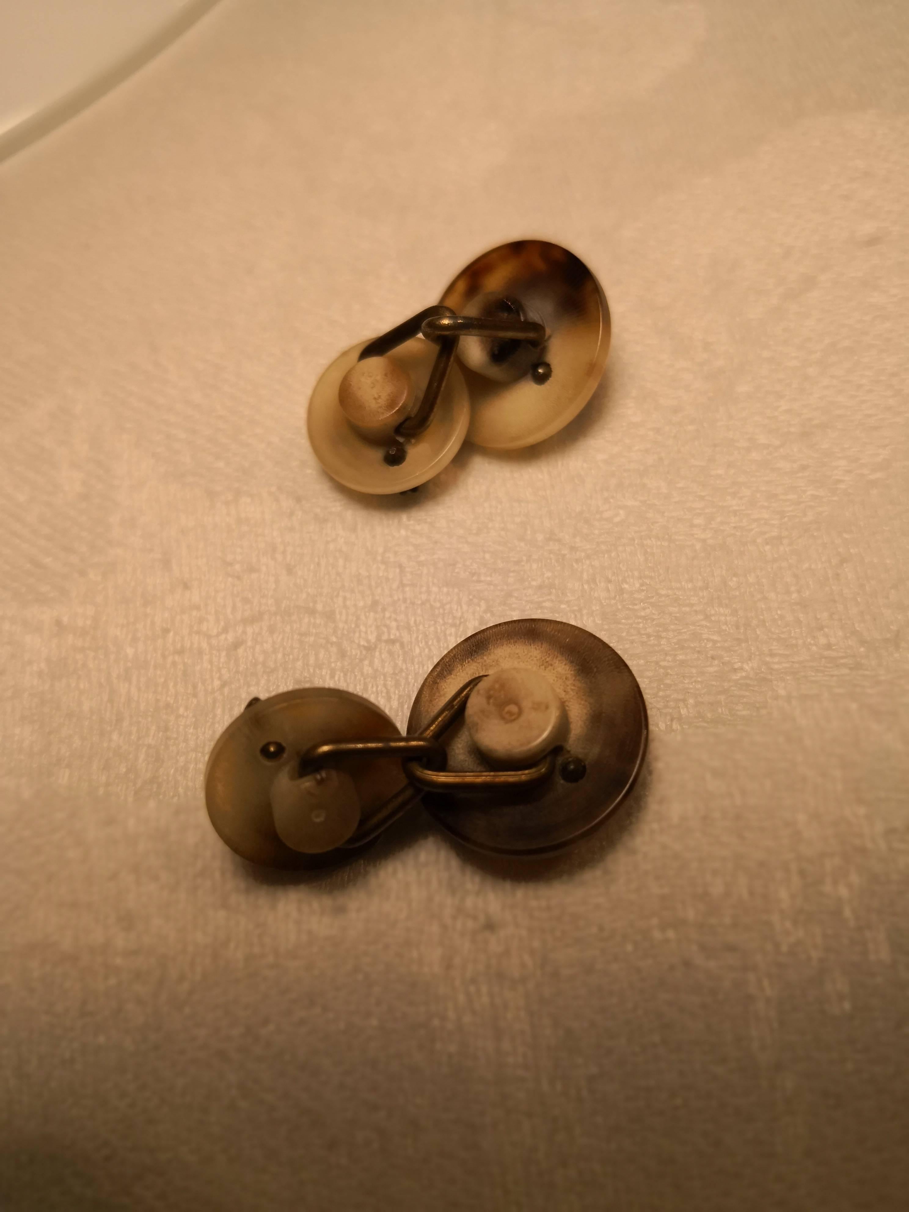Charming pair of cufflinks from Hermes in horn. The cufflinks are made in two parts in the style of Black Forest. One bigger and one smaller round shaped horn stud. Both studs are decorated with the Hermes typical hunter blahorns. Signed Hermes