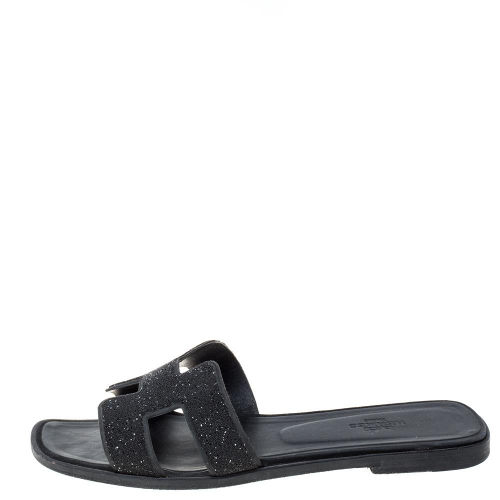 Put your best foot forward this season in these pretty Hermes sandals. These black Oran sandals have been crafted from glitter in Italy and they feature the iconic H on the vamps as well as insoles meant to provide comfort at every step. These