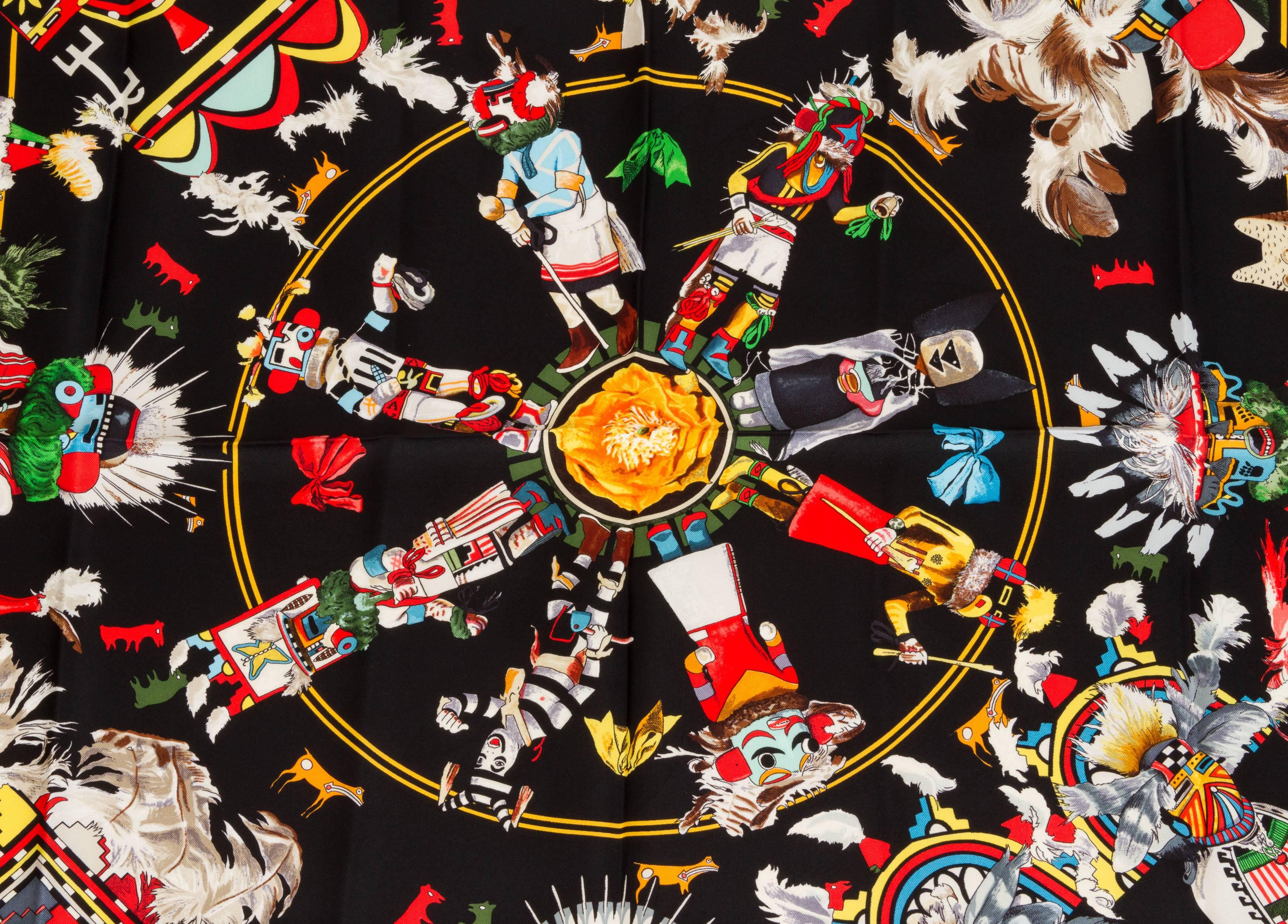 Hermès black silk twill Kachinas print scarf by Texan artist Kermit Oliver. One of his most coveted designs with a 1992 issue date. Showcasing American Indian Kachina dolls. Hand-rolled edges.  Two small holes at the bottom have been professionally