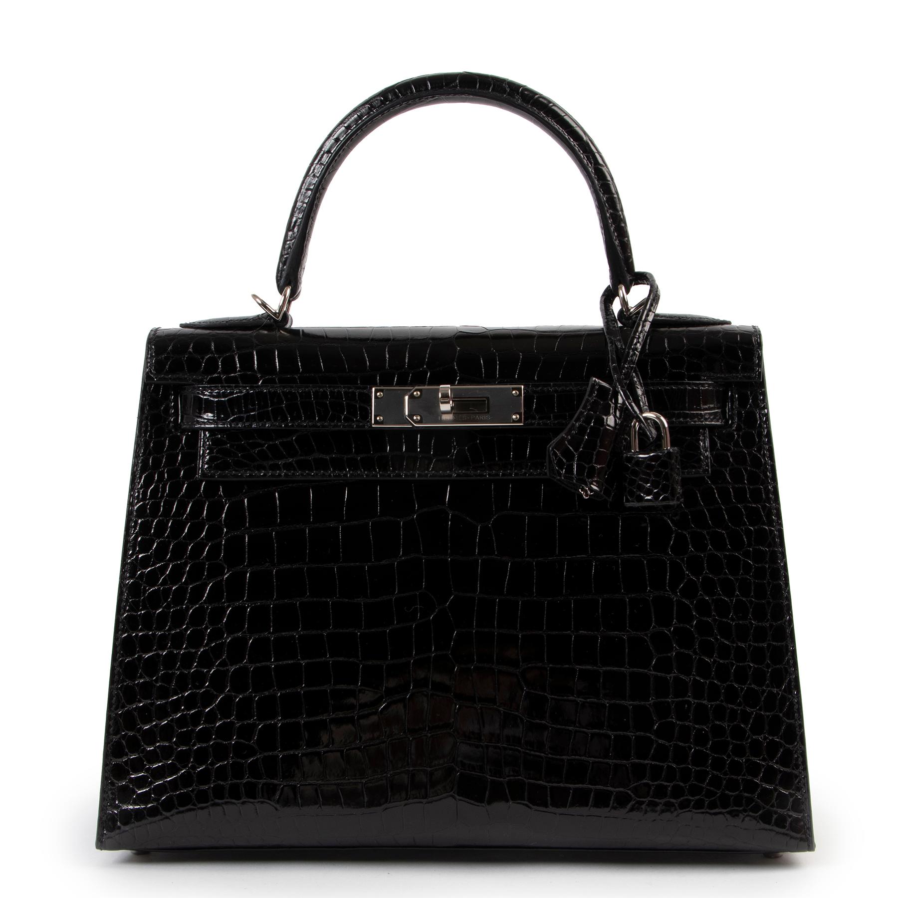 Get your hands on this very rare and hard to find HERMES Kelly 28 in crocodile Porosus Lisse. 
Crafted from shiny porosus crocodile skin, which is denoted by the circumflex symvol (^) in the embossing and often lauded as the most precious of the