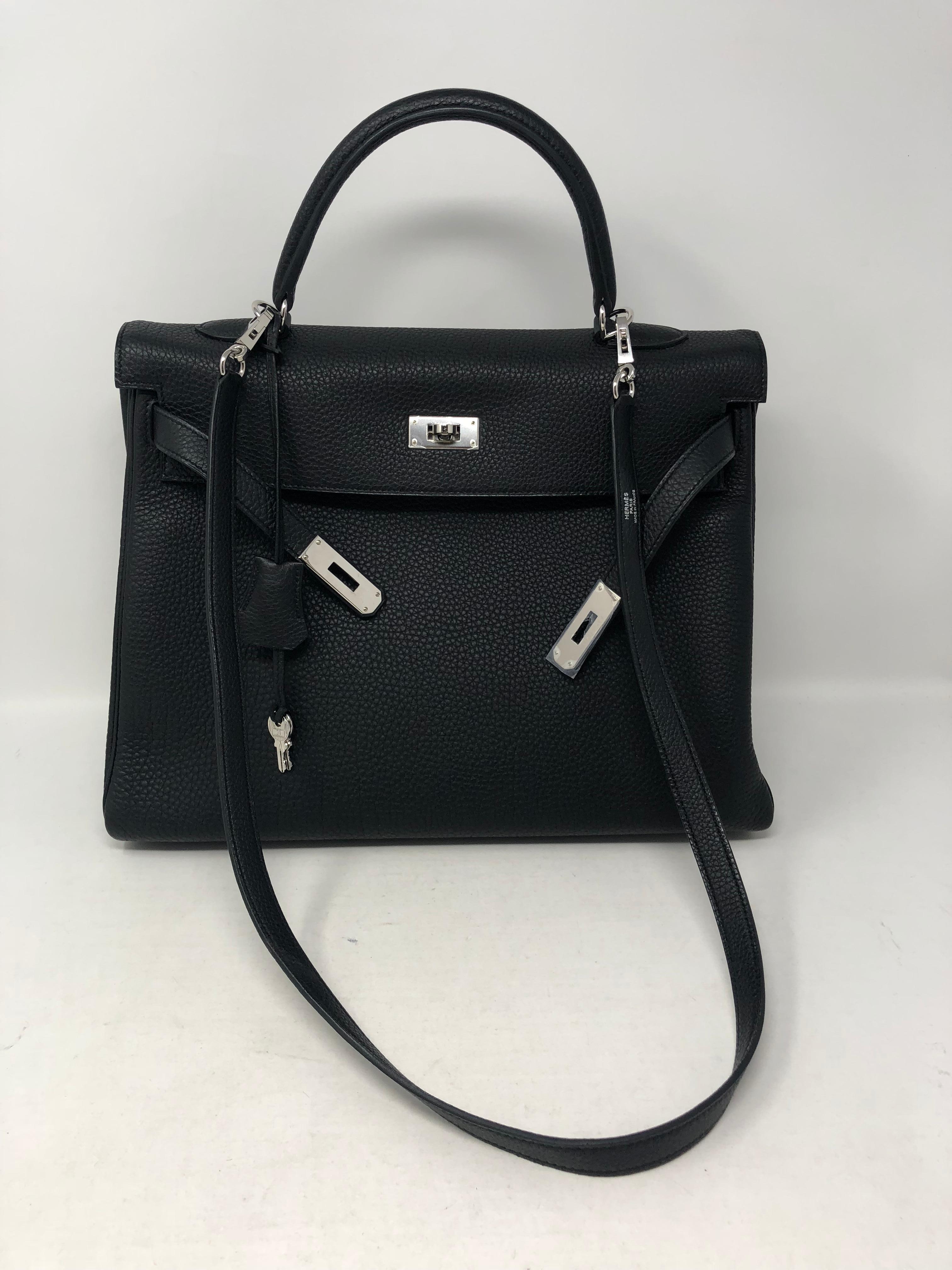 Hermes Black Kelly 35 Togo leather with Palladium hardware. Still has plastic on hardware. Never worn. From 2012. Stayed in box and looks brand new. The most wanted black Kelly will always be a classic. Don't miss out on this one. Includes strap,