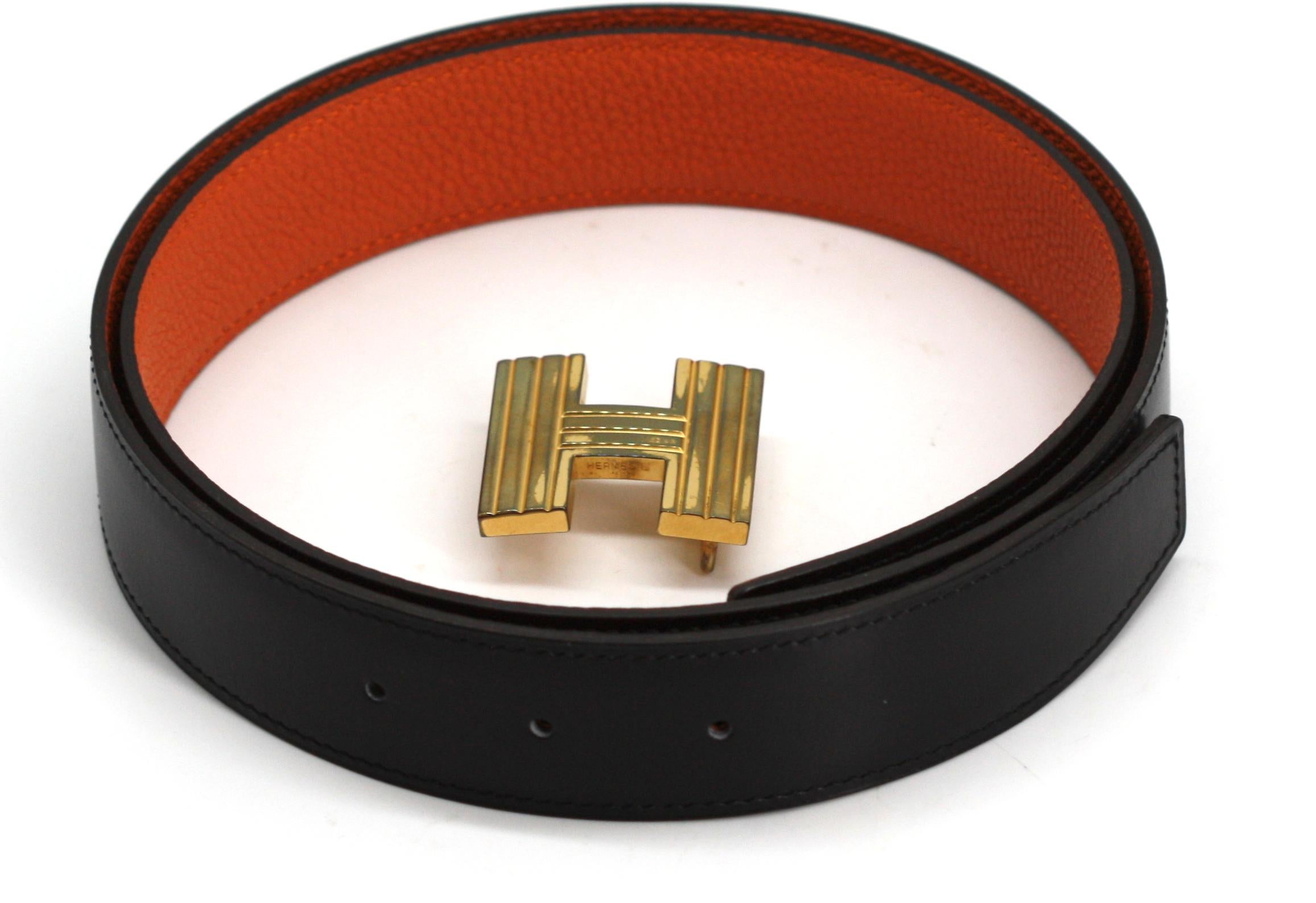 
Hermès Black Leather and Gold Toned Bronze Reeded H Buckle
The 41 inch stitched black leather strap, the reverse orange, the H buckle with textured with flutes, new, in the original fitted box.
Length 41 in., Width 1.5 in.
