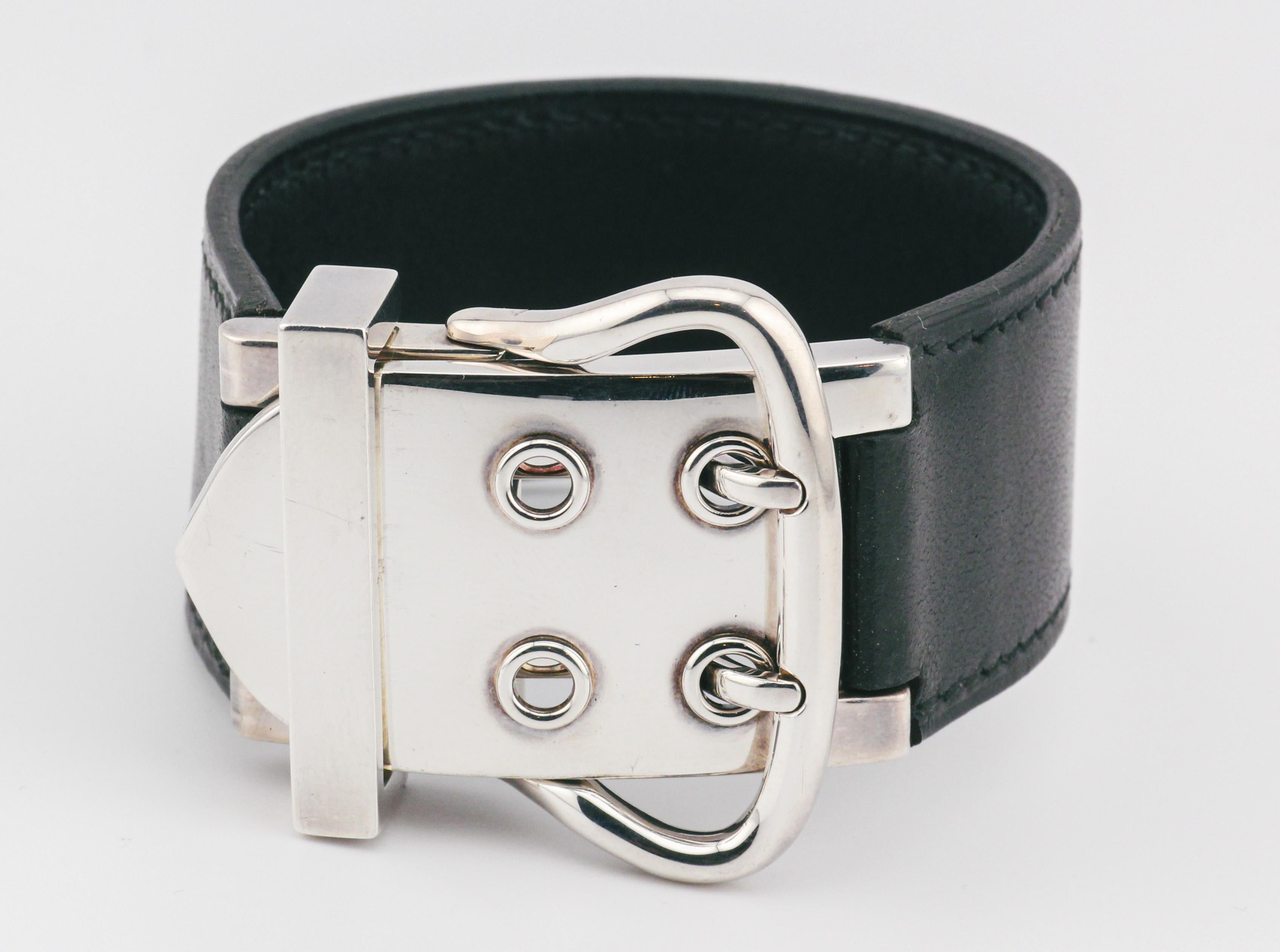 Elevate your wrist with the bold and refined elegance of this Wide Hermes Black Leather and Sterling Silver Buckle Bracelet. Meticulously crafted, this bracelet is a testament to Hermes' legacy of creating exceptional accessories that seamlessly