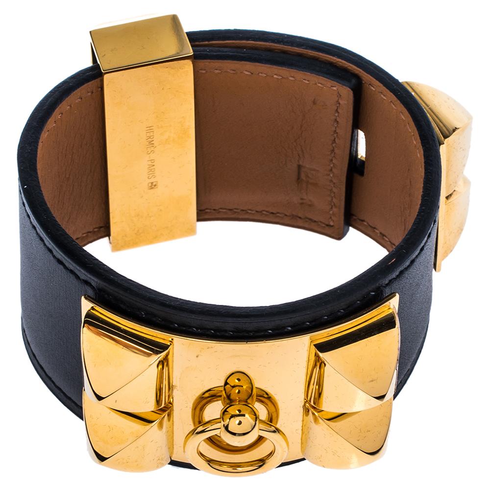 Exuding a downtown, punk vibe, this instantly recognizable bracelet is from the signature Collier de Chien collection of Hermès. The bracelet, made of leather, is adorned with the iconic Collier de Chien motif in gold plated metal featuring pyramid