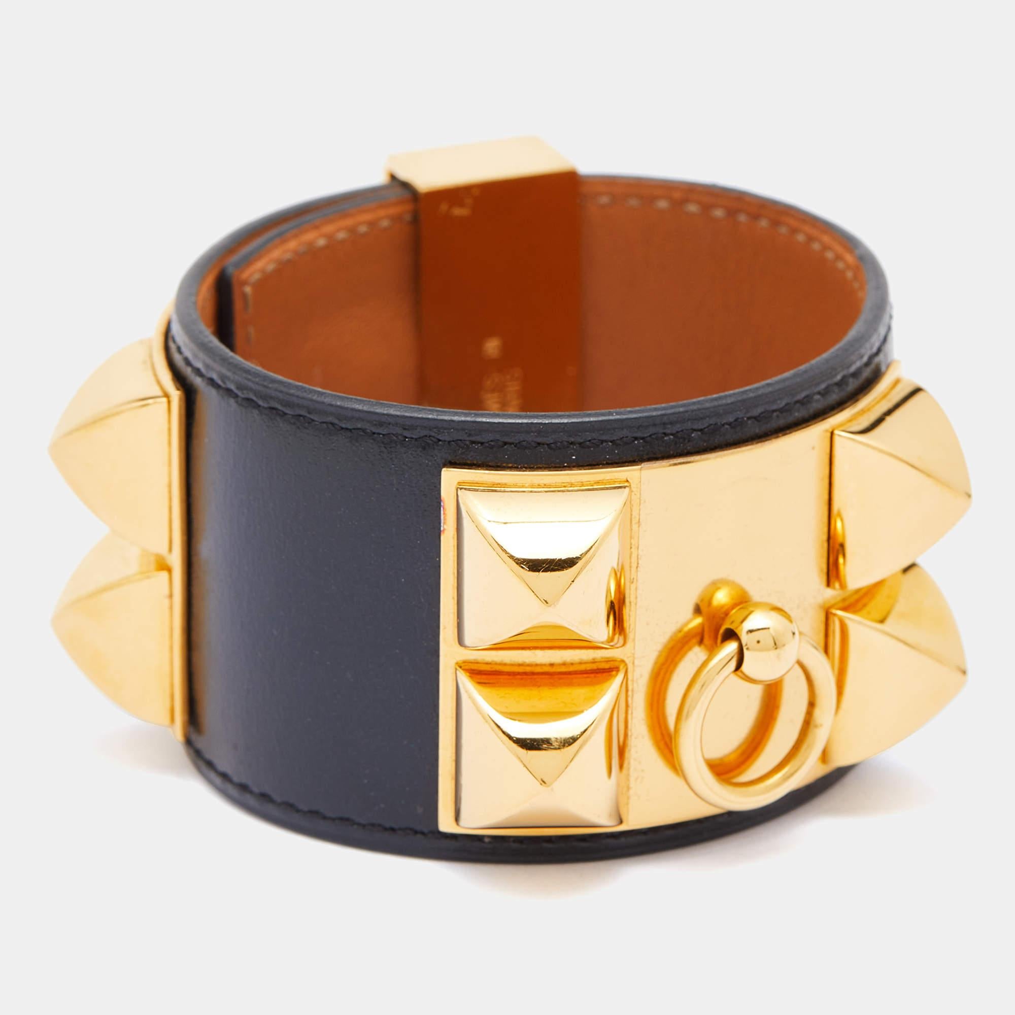 Exuding a downtown, punk vibe, this instantly recognizable bracelet is from the signature Collier de Chien collection of Hermès. The bracelet, made of leather, is adorned with the iconic Collier de Chien motif in gold-plated metal featuring pyramid