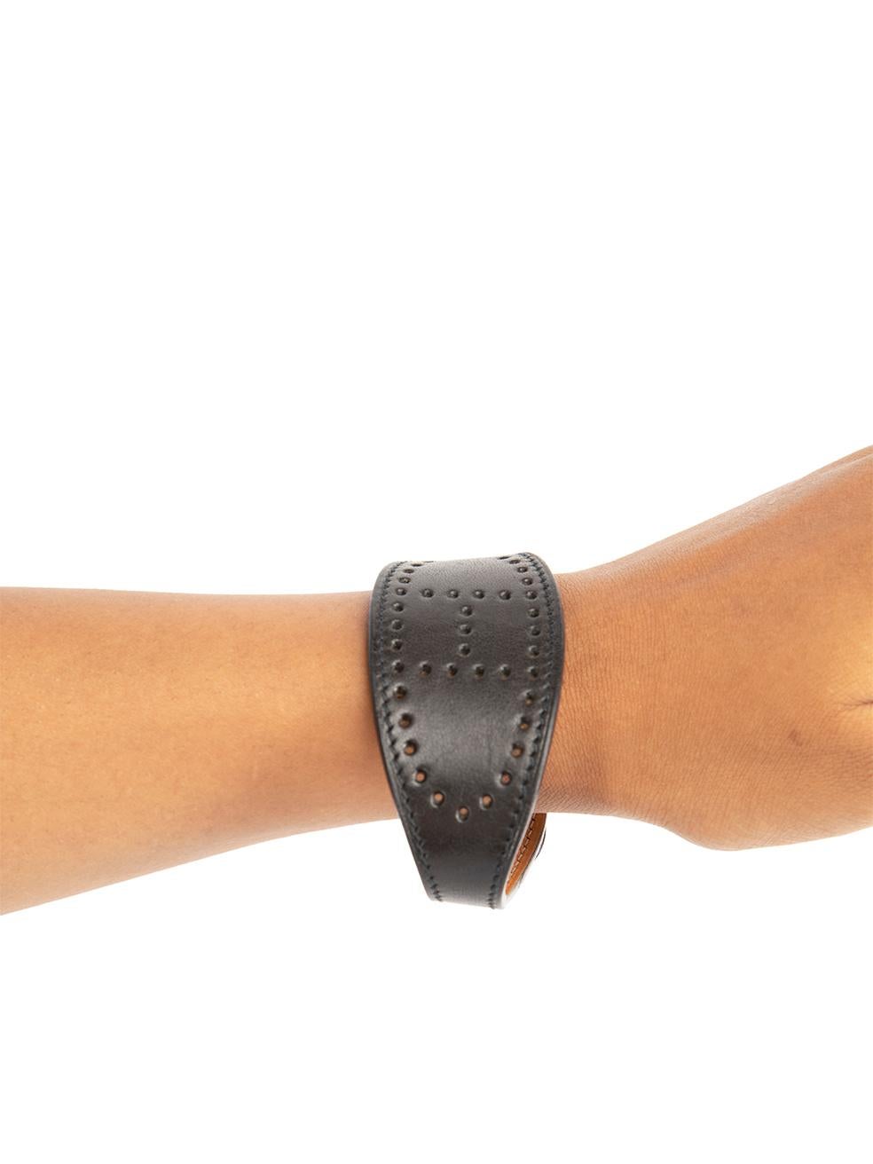 CONDITION is Very good. Minimal wear to bracelet is evident. Minimal wear to the leather underside with very light mark by the fastening on this used Hermès designer resale item.
  
  Details
  Evelyne
  Black
  Leather
  Bracelet
  Perforated logo