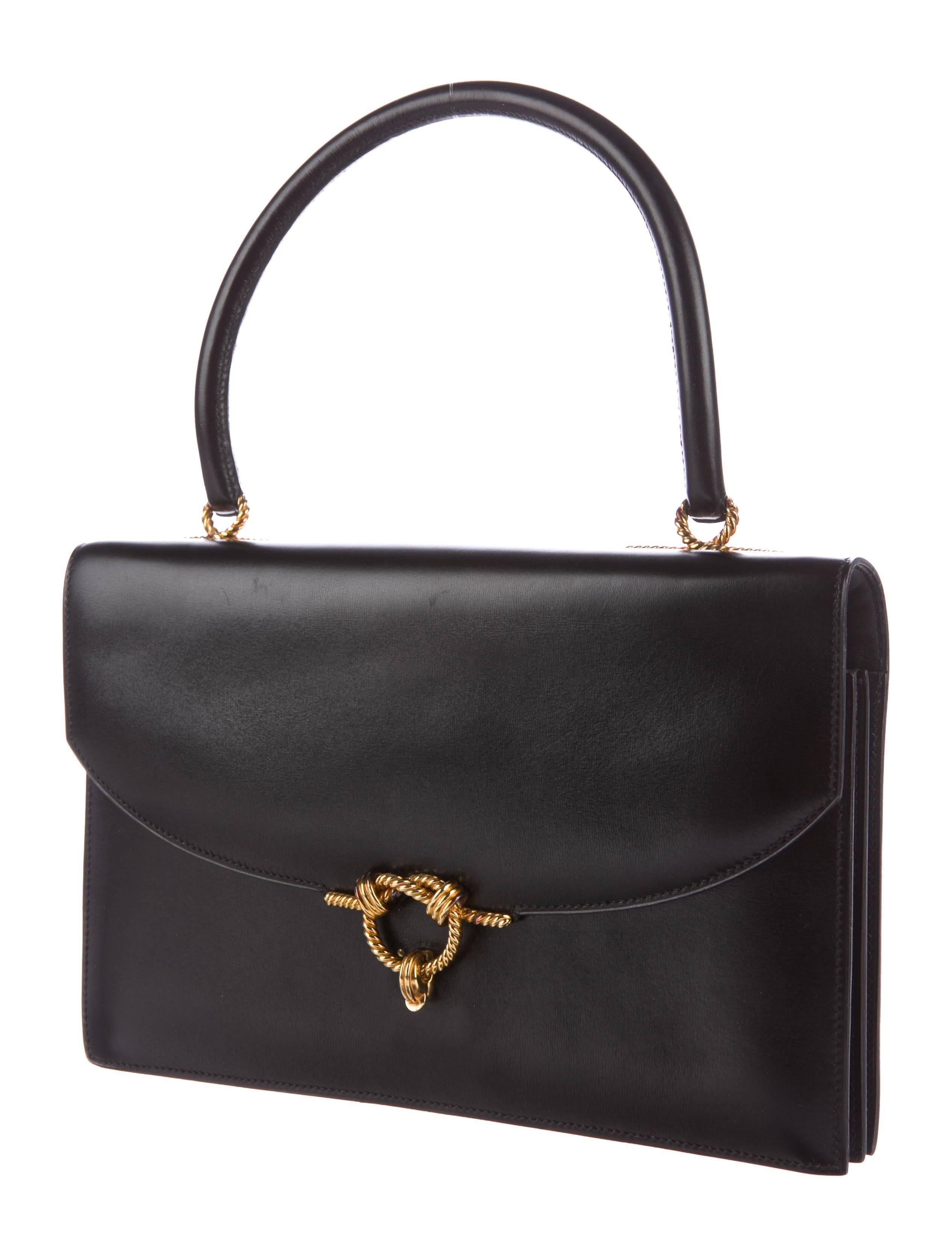 CURATOR'S NOTES

Hermes Black Leather Gold Rope Kelly Style Evening Top Handle Satchel Flap Bag

Leather
Gold tone hardware
Leather lining
Flip lock closures
Blind stamped
Made in France
Handle strap drop 5