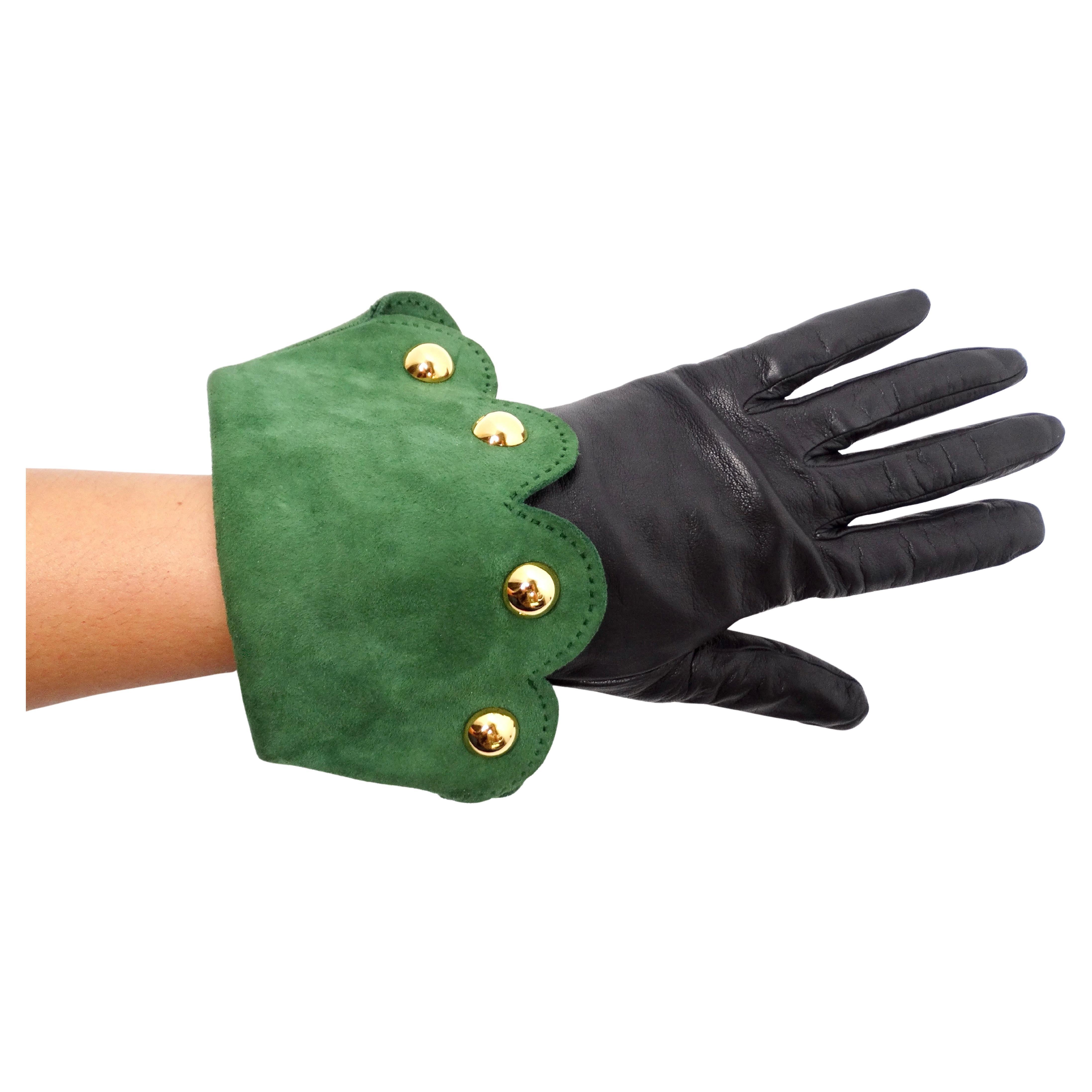The Hermes Black Leather & Green Suede Studded Gloves from the circa 1990s embody a sophisticated blend of luxury and edgy design. Crafted from supple black leather, these gloves exude timeless elegance, while the green suede scalloped fold-over
