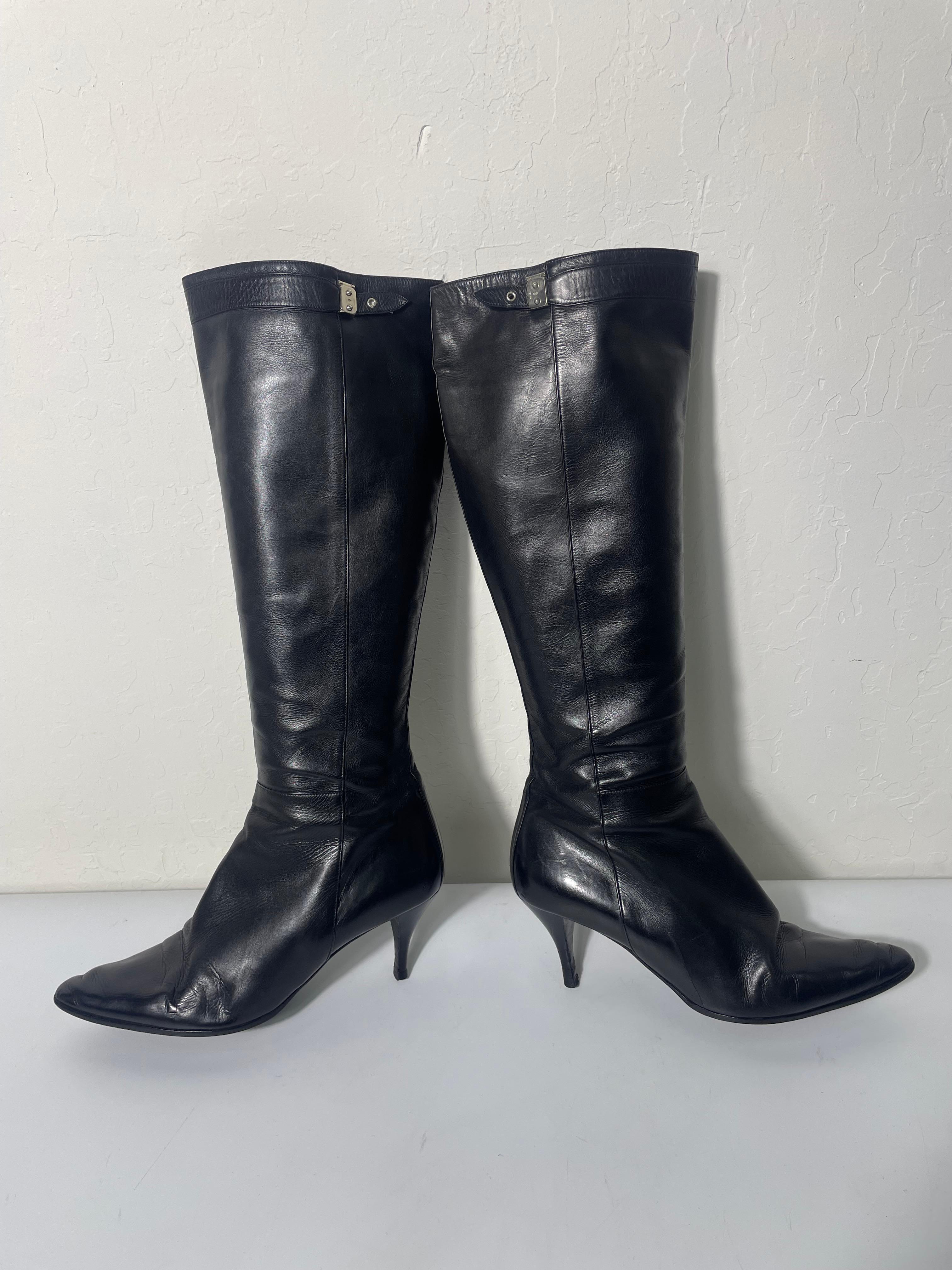 Hermes black leather boots with faux buckle detail. The clasp and strap are decorative, not functional. 

While these are in good used condition, these do show signs of normal wear. There are some light scuffs on both heels.

These are stamped size