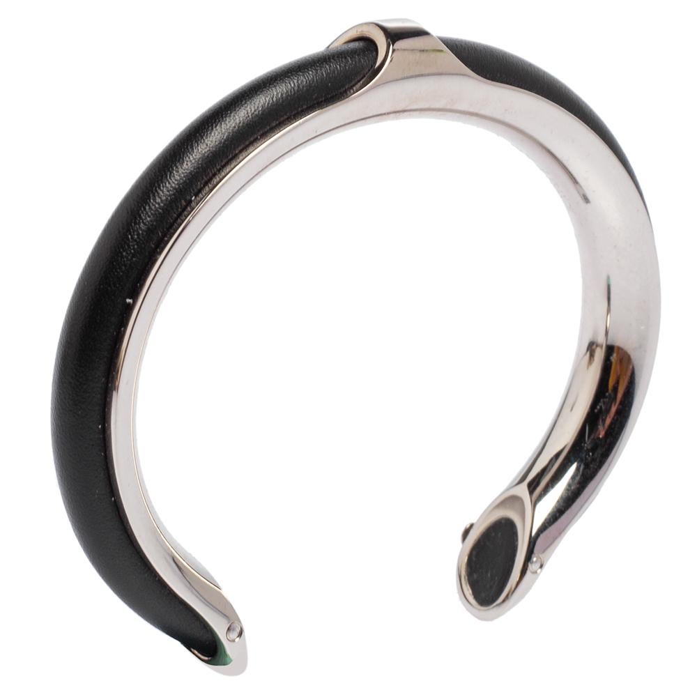 Simplicity and class combine to form this exquisite Hermes Kyoto bracelet just for you. It is made from palladium-plated metal and black leather in an open cuff style. It will make a fine statement accessory.

Includes: Original Dustbag
