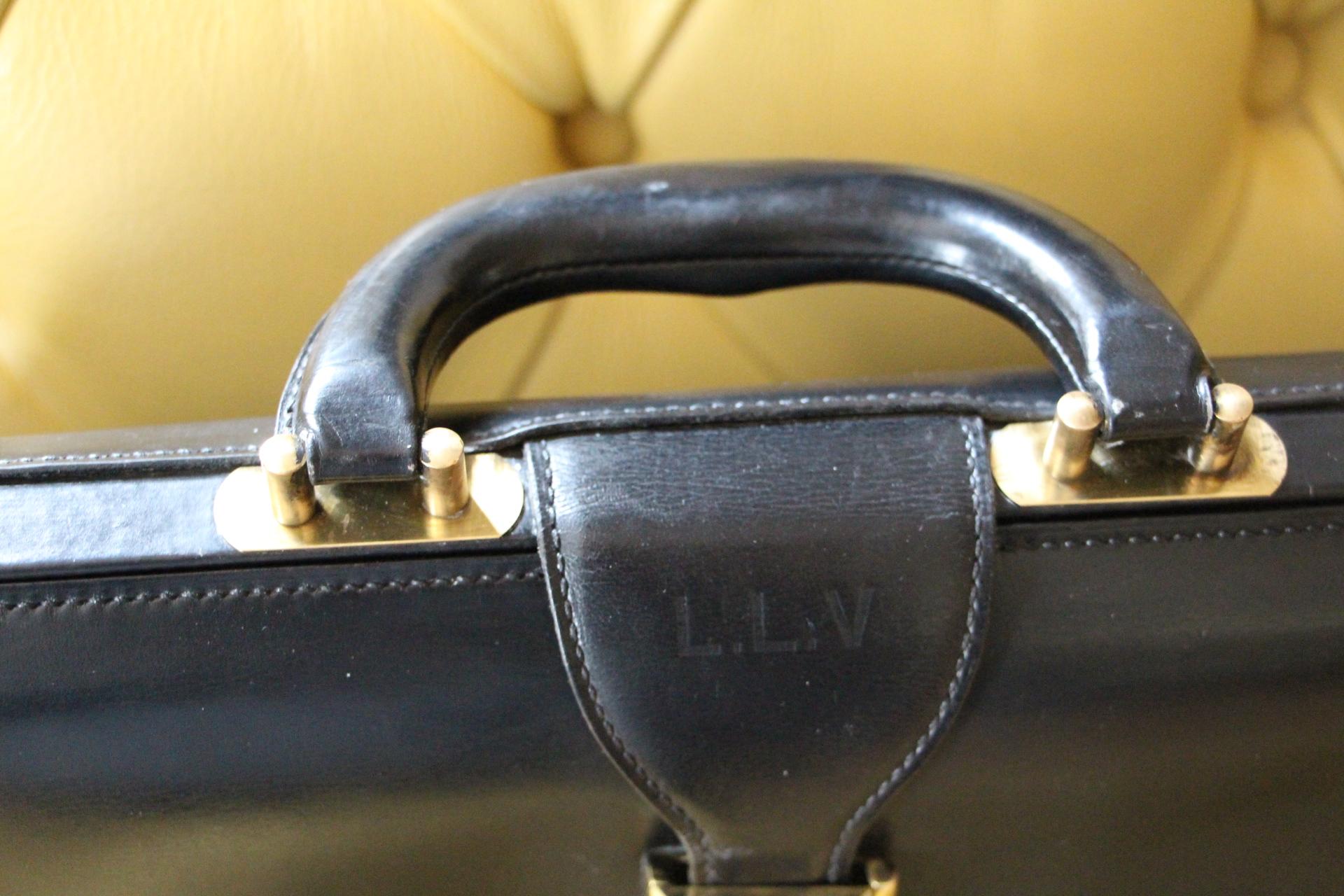 This very unusual Hermès briefcase features black leather and solid brass stamped Hermès lock. It also has got a beautiful all leather very comfortable handle in pristine condition. Above its lock, leather wears embossed LLV initials.It is stamped