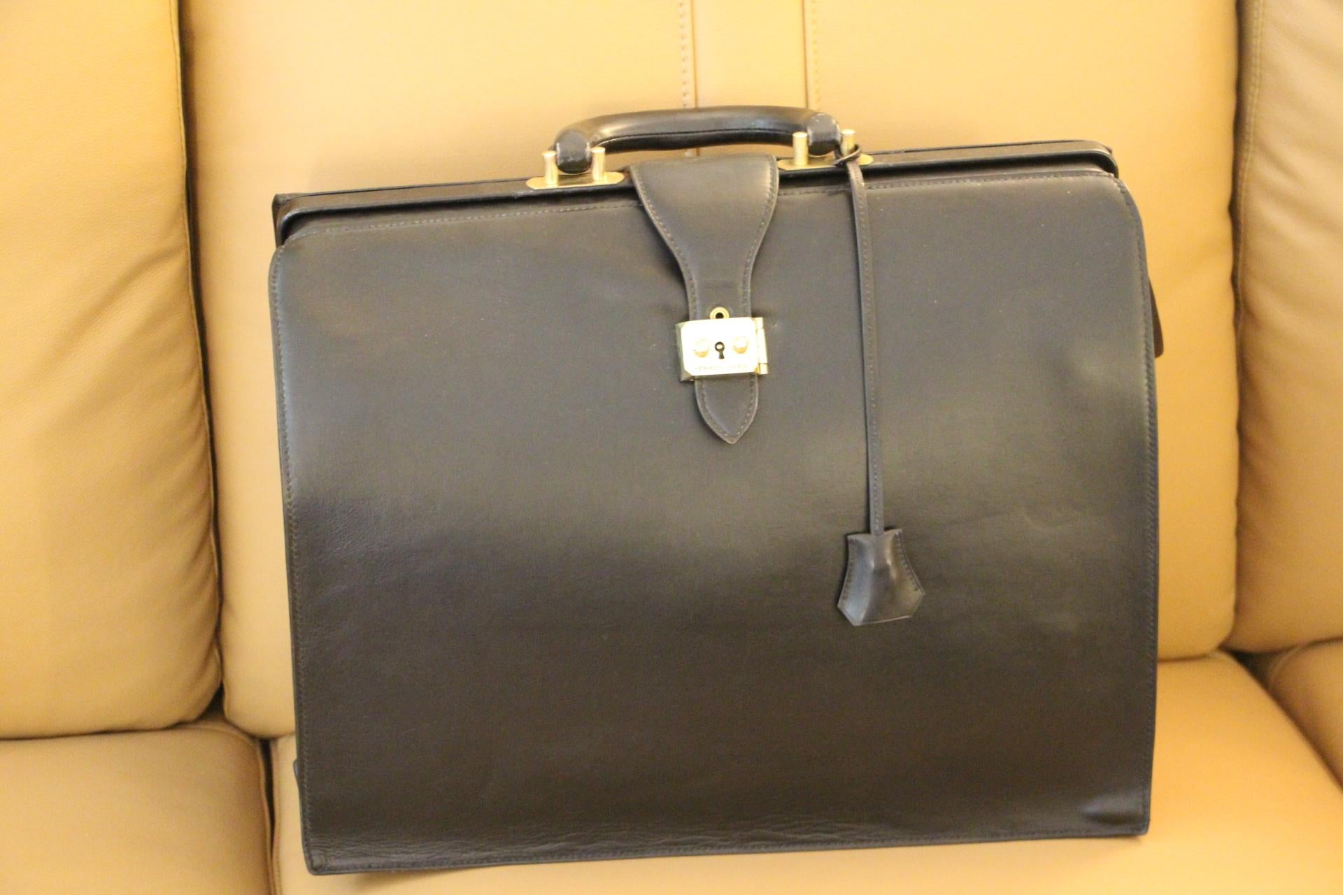 This very unusual Hermès briefcase features black leather and solid brass stamped Hermès lock. It also has got a beautiful all leather very comfortable handle in pristine condition .It is stamped Hermès Paris in gold under its flap. Sold with