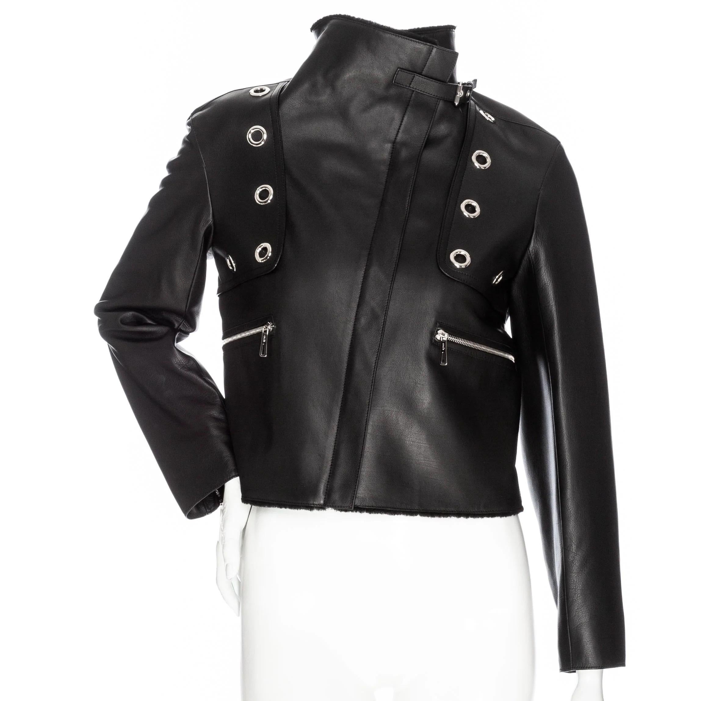 Hermès Black Leather Shearling-Lined Cropped Biker Jacket

Black
Silver-tone hardware
Logo embossed zipper pulls
Grommet accents
Shearling collar and trim
Optional belted collar strap
Classic biker zippers on cuffs
Front zippered pockets
Concealed