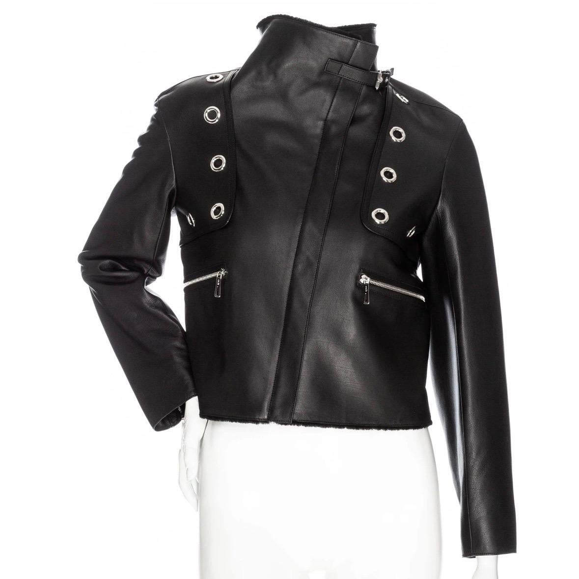 Hermès Black Leather Shearling-Lined Cropped Biker Jacket  

Black
Silver-tone hardware
Logo embossed zipper pulls
Grommet accents
Shearling collar and trim
Optional belted collar strap
Classic biker zippers on cuffs
Front zippered pockets
Concealed