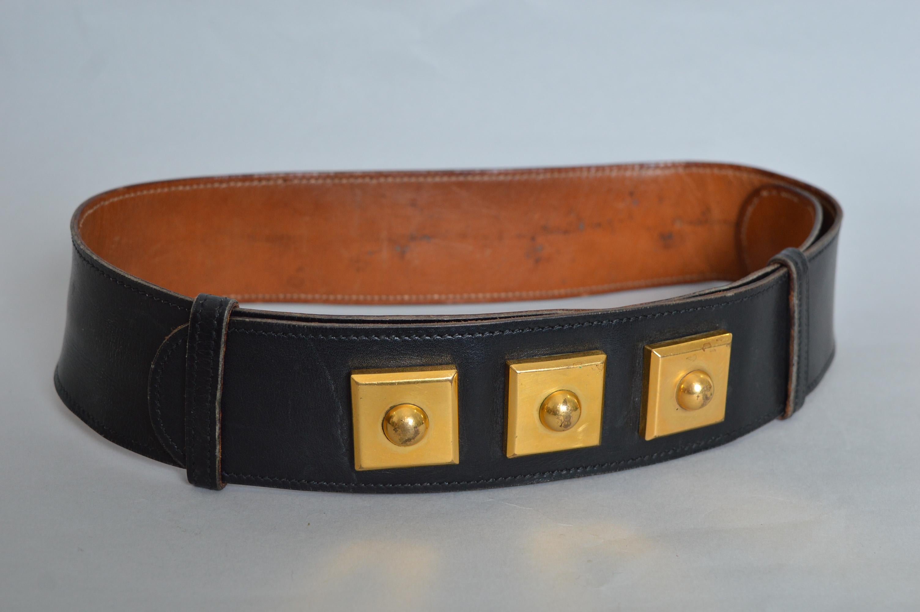 Superb Vintage Hermès Black leather waist belt with decorative Gold square details on the front and tan leather lined interior. 
Circa 1950.
The belt is Stamped in gold lettering ‘HERMÈS-PARIS, 24.FgStHONORÉ’.
Size; Adjustable from 24 to 27”