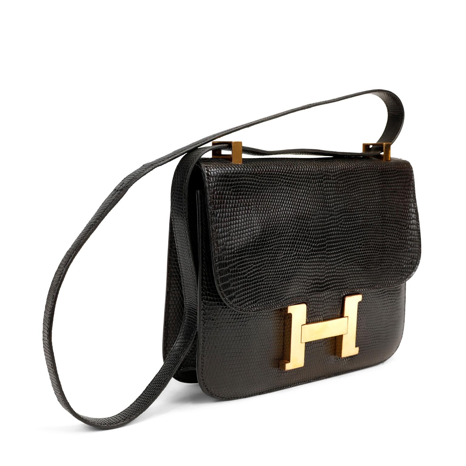 This authentic Hermès Black Lizard Constance is in beautiful vintage condition with mild signs of prior ownership.
The Constance has simple clean lines and combines classic with modern. The large gold tone signature Hermès architectural H spring