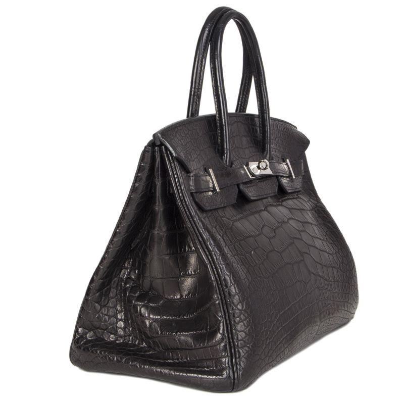 Hermes 'Crocodile Birkin 35' in black matte alligator. Lined in Chevre (goat skin) with an open pocket against the front and a zipper pocket against the back. Has been carried and is in excellent condition. Comes with keys, lock, clochette and dust