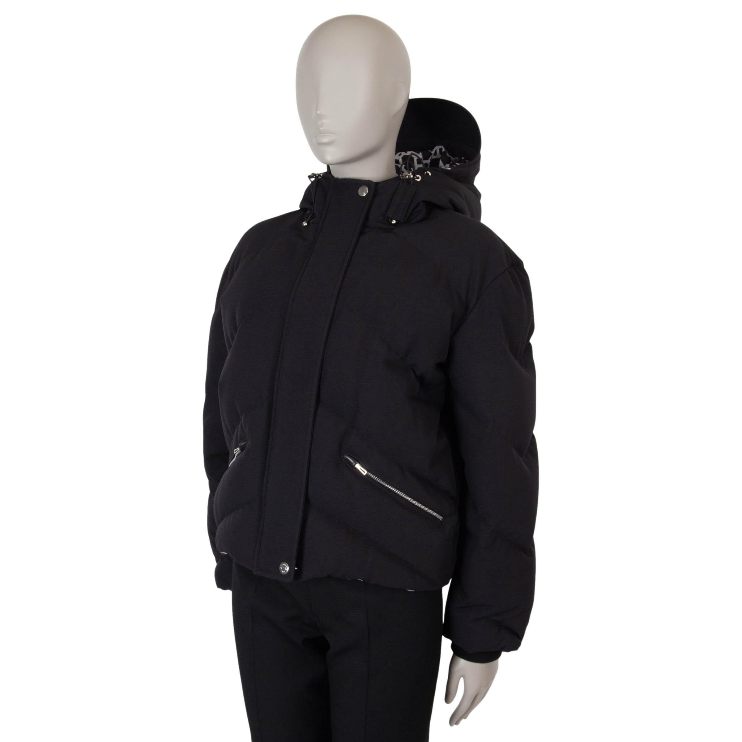 This 100% authentic Hermès puffer jacket in black Plume canvas (100% polyamide) combines high-performance design with signature elegance. Featuring a cropped silhouette with chevron quilting, it is equipped with a hood and waist cinched by