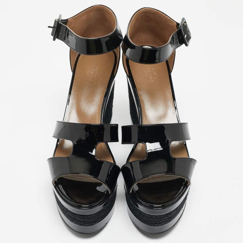 Leave everyone in awe when you sashay out in this spellbinding pair of sandals from Hermes. The pair has been designed with front H straps made from patent leather and covered counters and ankle fastenings with silver-tone buckles. But it is their