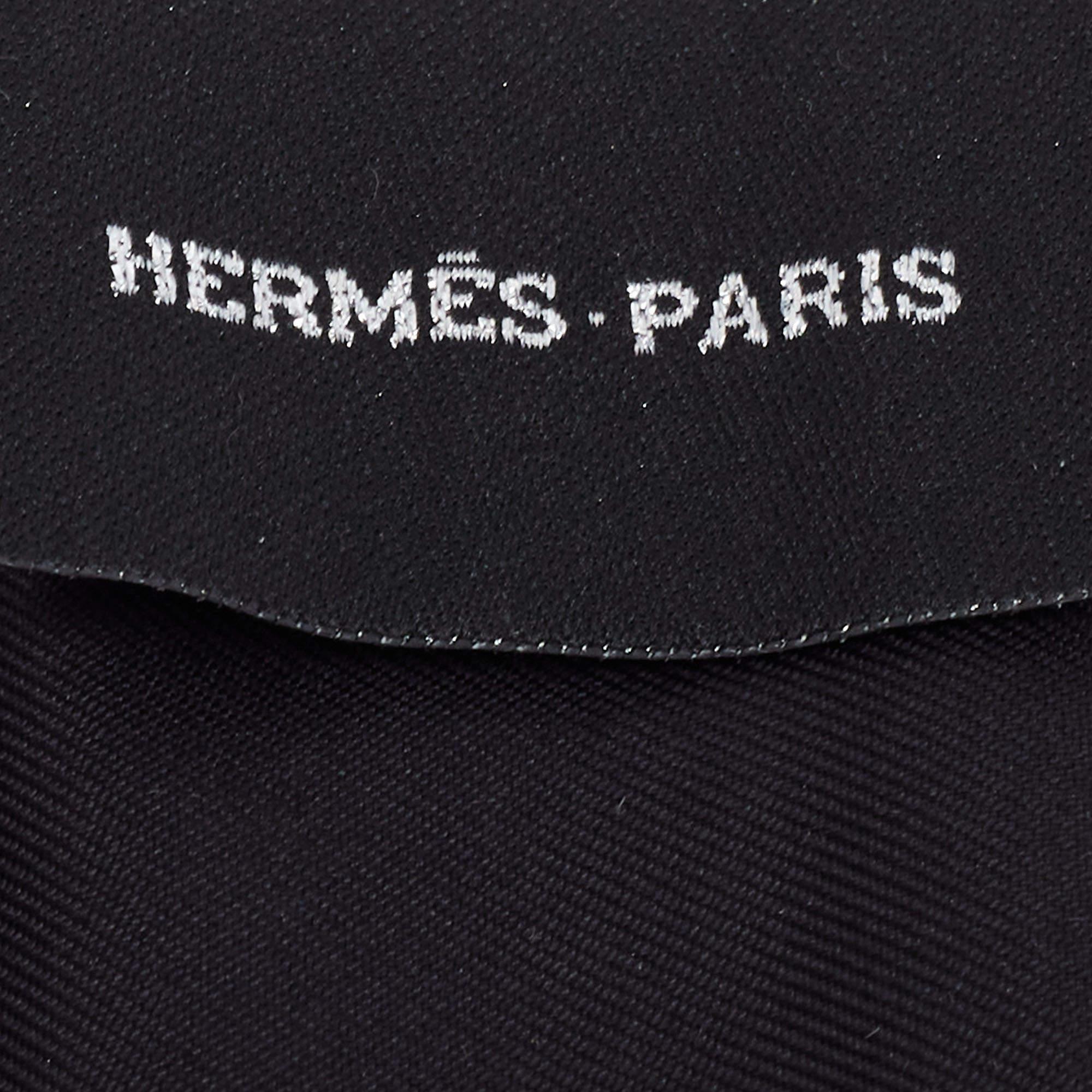 The Hermès twilly is an exquisite accessory crafted from luxurious silk adorned with shimmering black sequins. This versatile and elegant piece can be worn as a headband, necktie, or wrapped around a handbag handle, adding a touch of sophistication