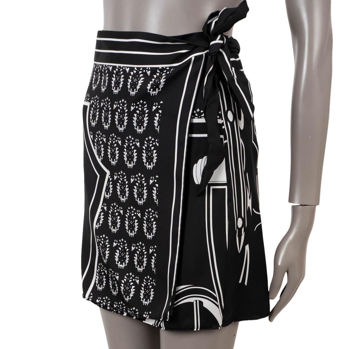 100% authentic Hermès wrap mini skirt in black and white silk (100%) with Les Roues de Phaeton print. Closes with conceled buttons and ties on the side. Has been worn and is in excellent condition.

Complete the look with matching blouse available