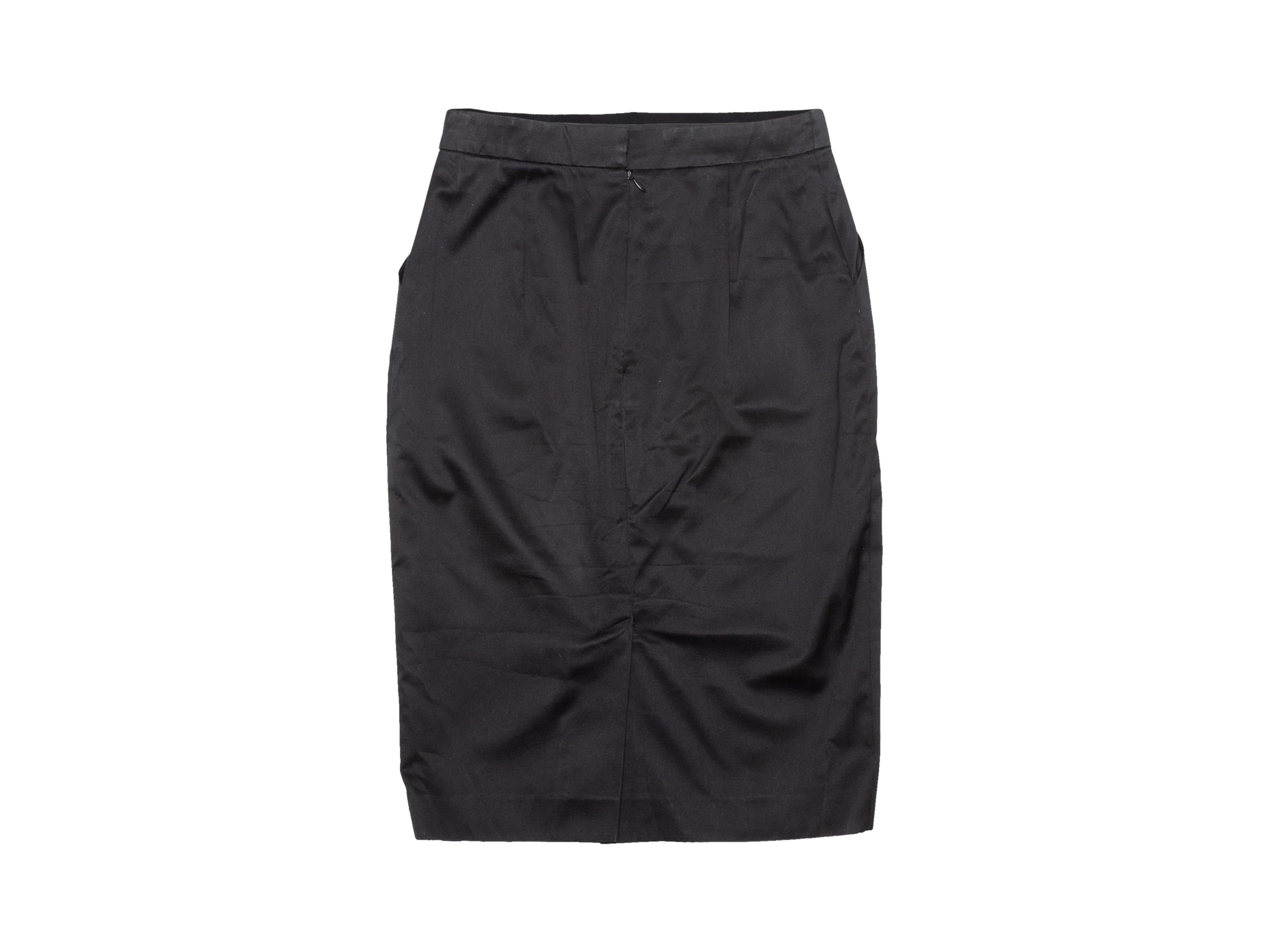 Product details: Vintage black silk knee-length pencil skirt by Hermes. Concealed zip closure at back. Designer size 34. 26