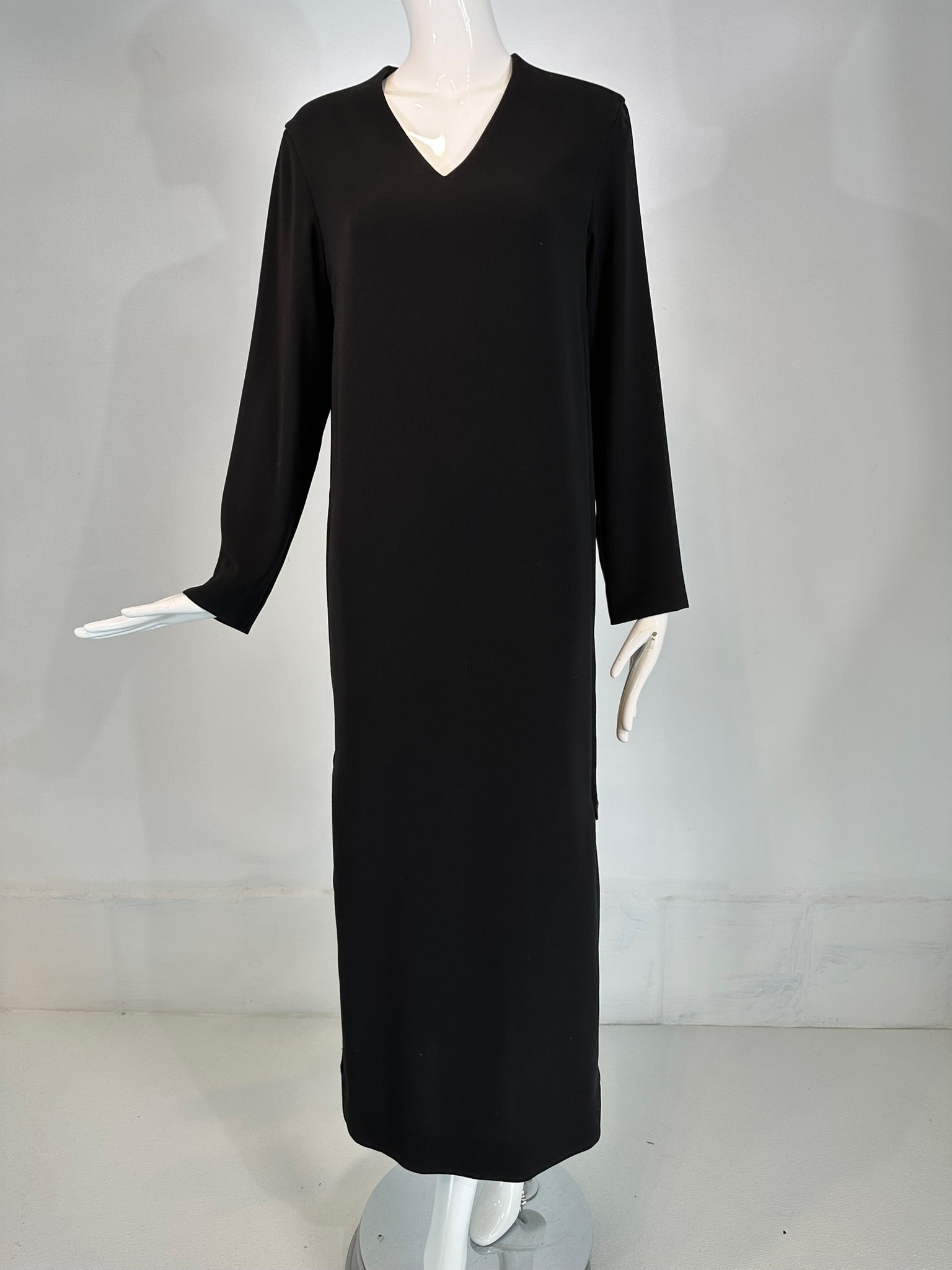 Hermes black silk, V neck, long sleeve maxi dress with full length side zippers. Vintage dress is unique in that it has full length zippers at each side from the hem to the underarm. Each painted metal zipper has a black leather pull tab. Beautiful