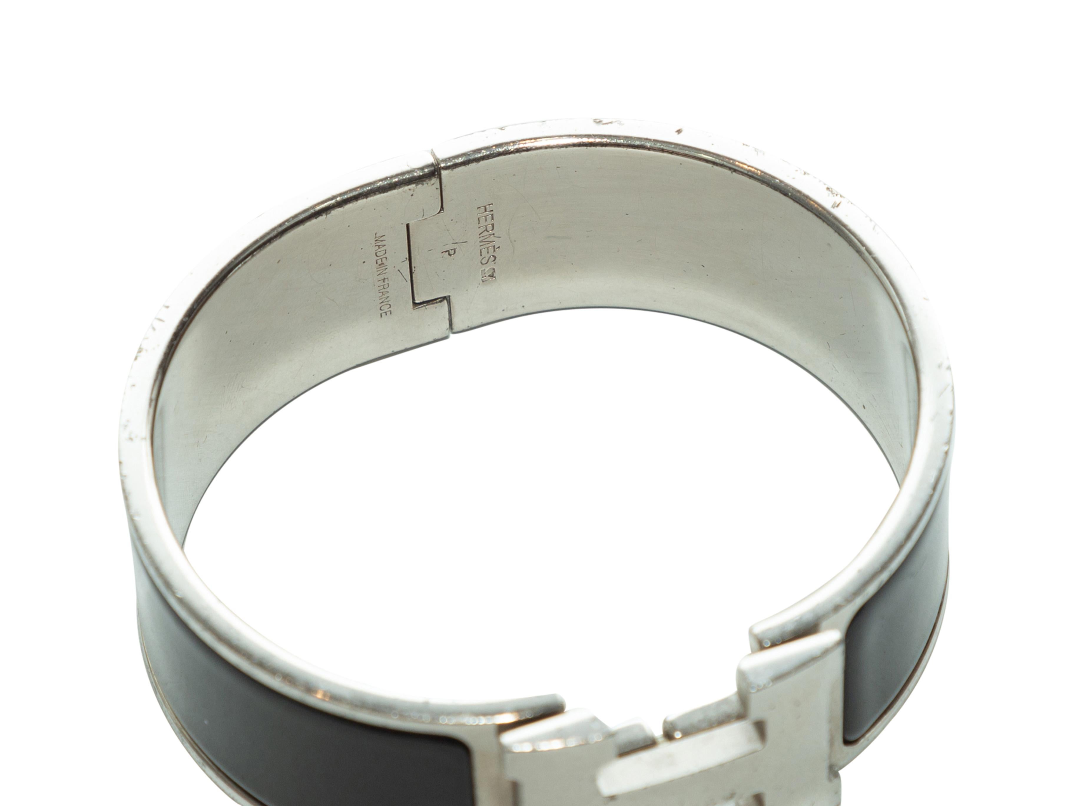 Product details: Black and leather Clic Clac logo bracelet by Hermes. H logo closure at top. 2