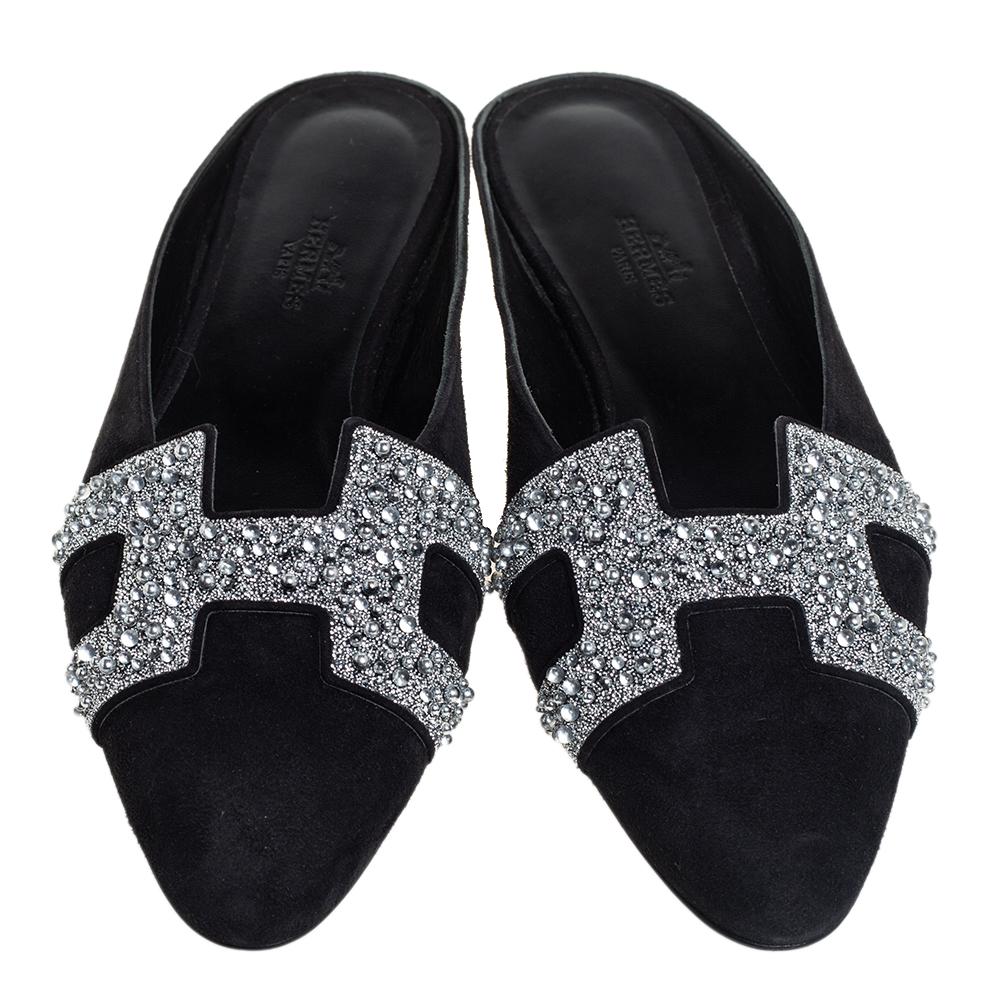 Supremely comfortable and stylish, these black and silver mules from the house of Hermes features a suede and crystal-embellished body. They come with the signature 'H' details on the vamps and leather insoles. Style with culottes or cropped