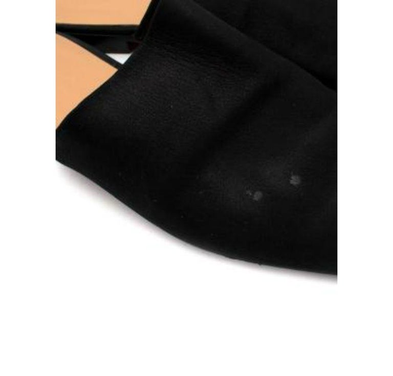 Hermes Black Suede Slippers
 
 - Babouche style, slip-on slippers, with a squared-off toe, high vamp suede exterior, and flat leather sole, with rubber coating
 
 Materials; 
 Suede 
 Rubber
 
 9.5 excellent 2 faint marks on one upper, which may be