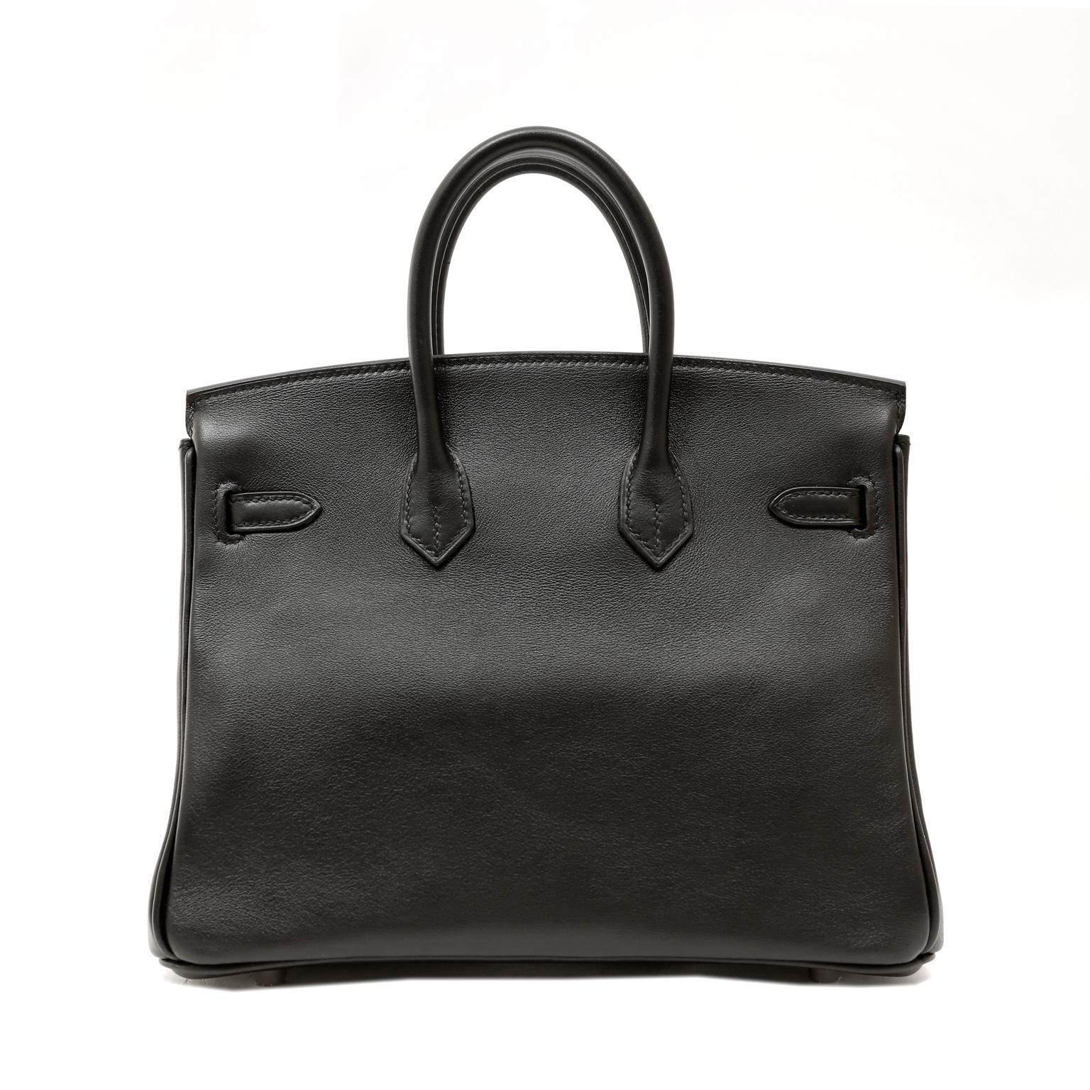 This authentic Hermès Black Swift Leather 25 cm Birkin Bag is in pristine unworn condition with plastic intact on the hardware.
Long waitlists are commonplace for the intensely coveted classic leather Birkin bag.  Each piece is hand crafted by