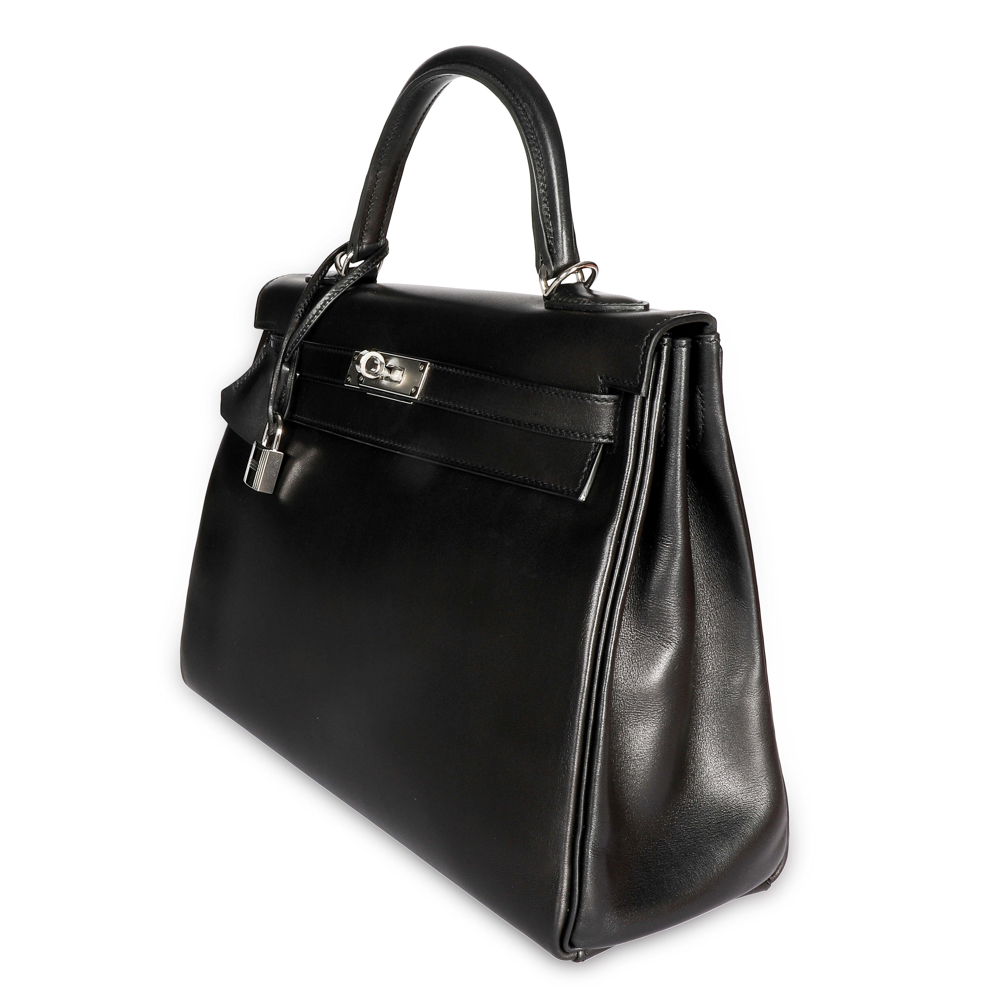 Listing Title: Hermès Black Swift Leather Retourne Kelly 28 with Palladium Hardware
SKU: 108273

Condition Description: First conceived in 1930, by Robert Dumas, as a classic and elegant bag for the modern and independent woman. It had been referred