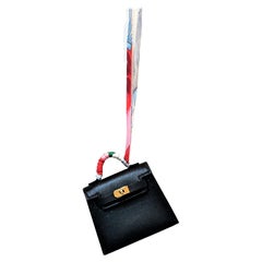 HERMÉS black Tadelakt Leather Twilly mini Kelly bag charm, gold hardware,  2021s