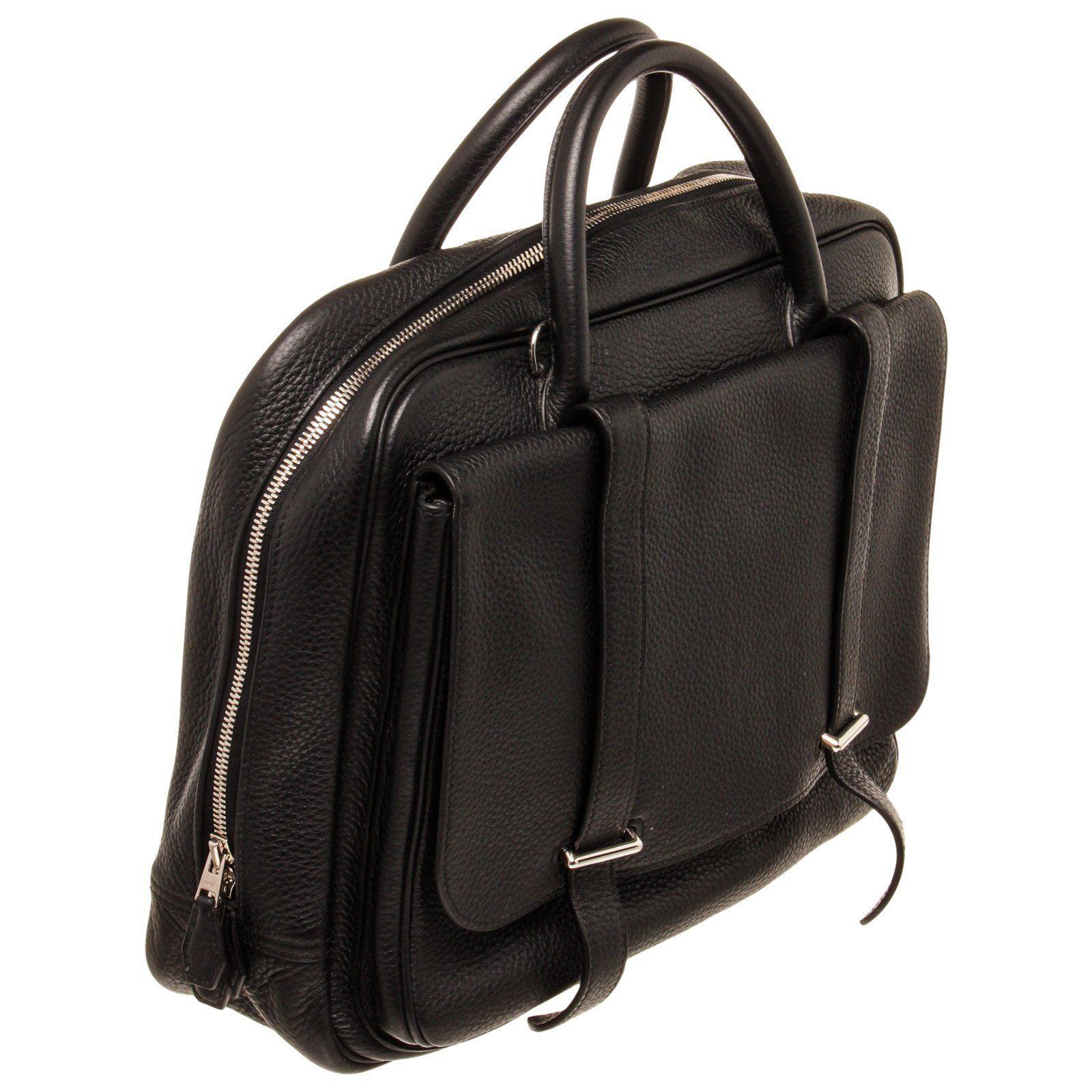 Hermes Black Taiga Leather Steve Travel Bag with silver-tone hardware, trim leather, canvas lining, dual top handle and Snap closure.


44720MSC