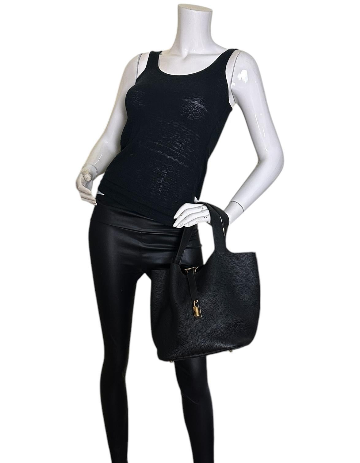 Hermes Black Taurillon Clemence Leather Picotin Lock 26 PM Bag

Made In: France
Year of Production: 2021
Color: Black
Hardware: Goldtone
Materials: Taurillon clemence leather
Lining: Suede
Closure/Opening: Open top with center tab
Exterior Pockets: