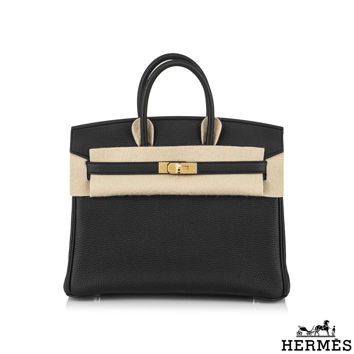An exquisite Hermès 25cm Birkin bag. The exterior of this birkin is in black togo leather with tonal stitching. It features gold tone hardware with two straps and front toggle closure. The interior is lined with black chevre and has a zip pocket