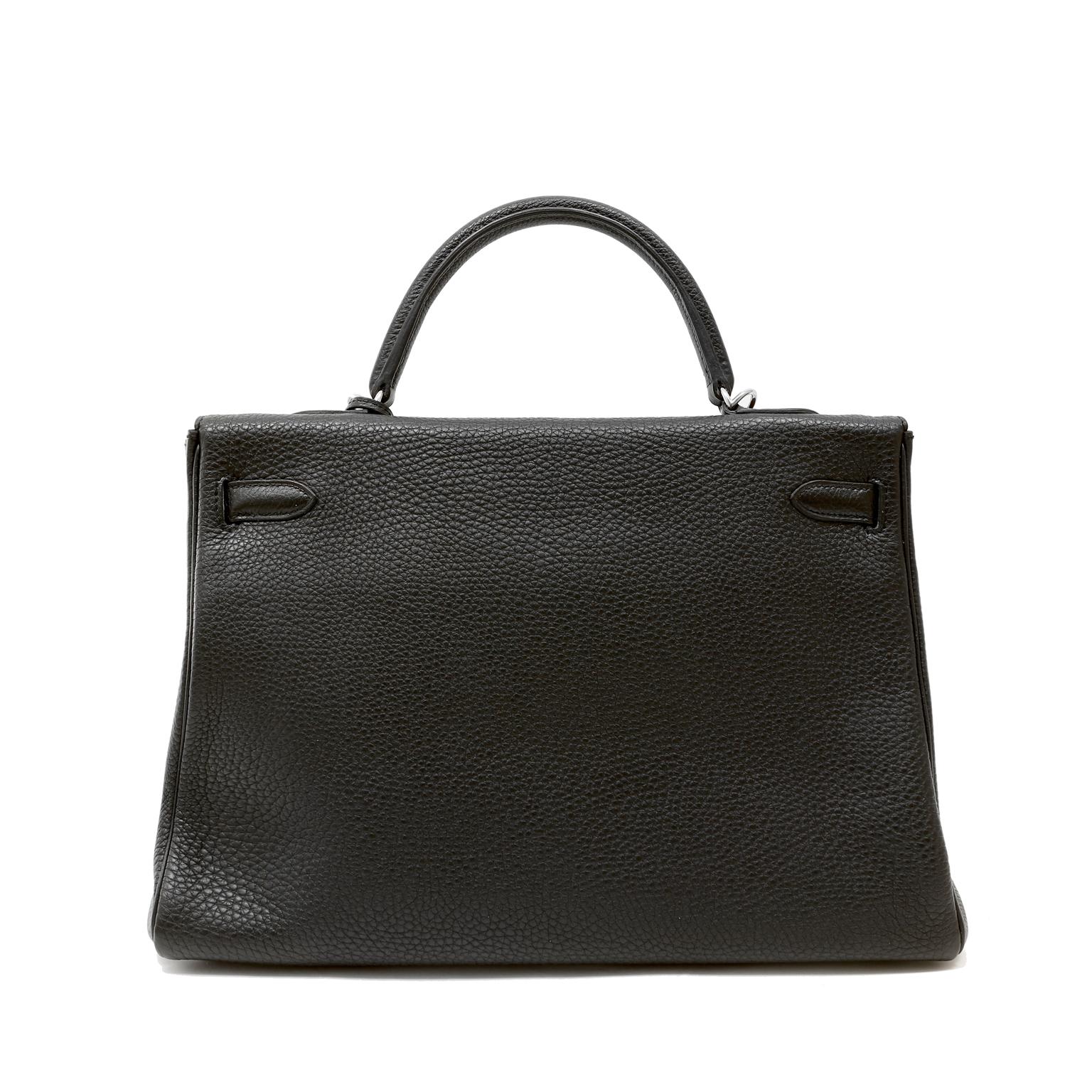 This authentic Hermès Black Togo 35 cm Kelly is in pristine condition with the protective plastic intact on much of the hardware.  The handstitched ladylike Kelly is in extremely high demand and black Togo accented with palladium is a timeless