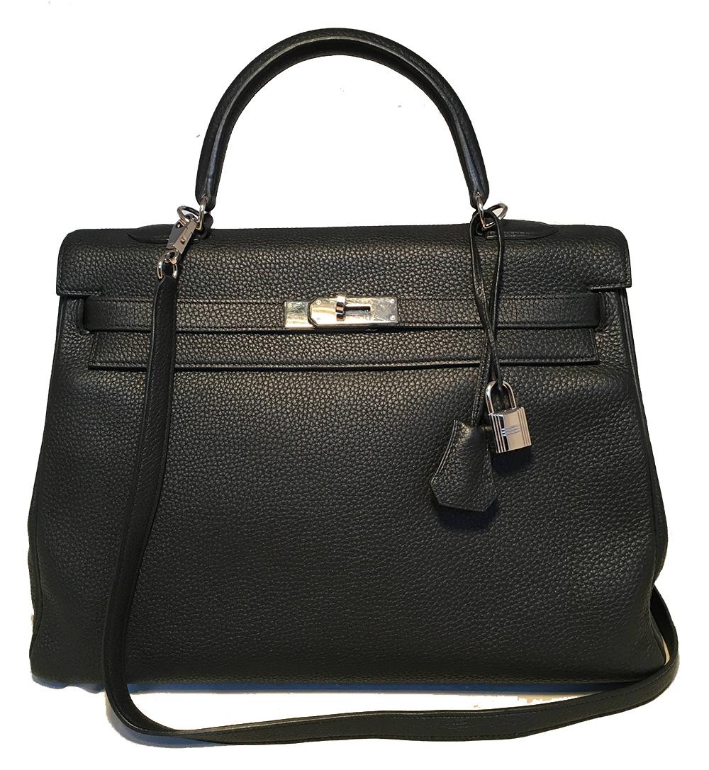 Hermes Black Togo Leather 35 cm Kelly Bag with Strap in excellent condition. Black togo leather exterior trimmed with silver palladium hardware. Signature twisting double strap closure opens to a matching black kidskin lined interior with one zip