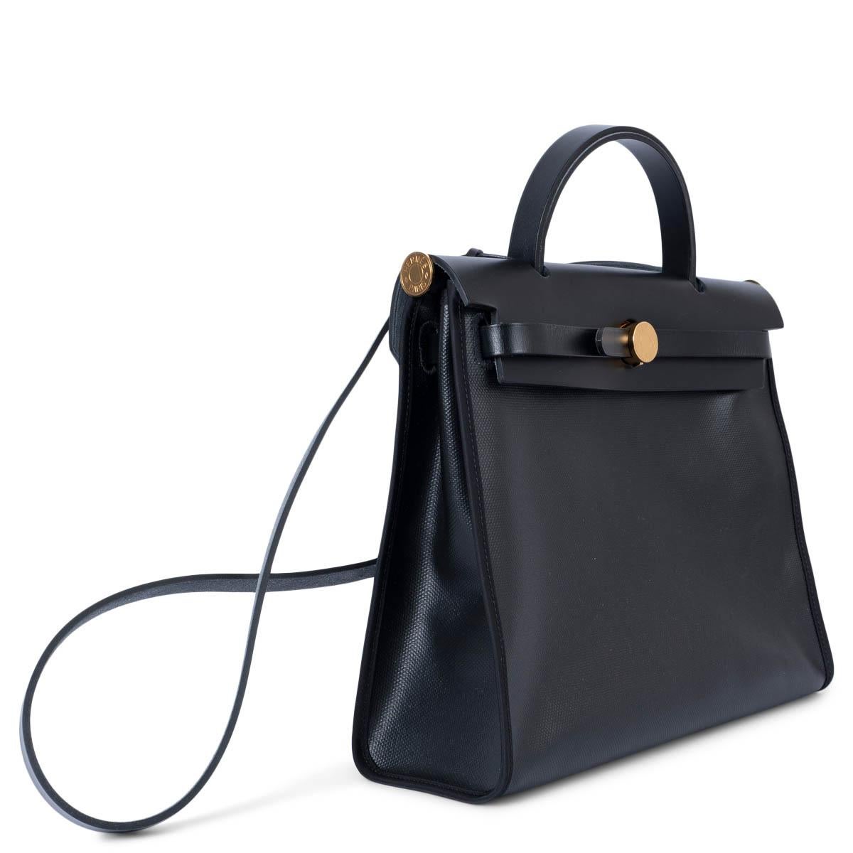 100% authentic Hermès Herbag Zip 31 in black coated Toile H Berline and black Vache Hunter leather with gold-tone hardware. The design features an exterior zip pocket on the back, has tonal stitching, front flap, clochette with lock and two keys,