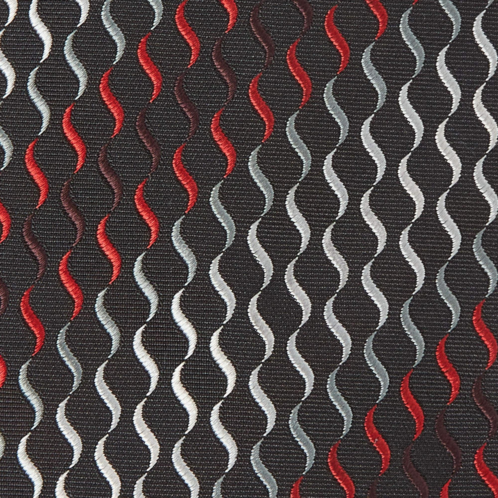 This tie is a perfect formal accessory that has a sharp and modern appeal. Made from luxurious materials  it features intricate patterns  and the brand label is neatly stitched at the back. It is sure to add oodles of style to your blazers.