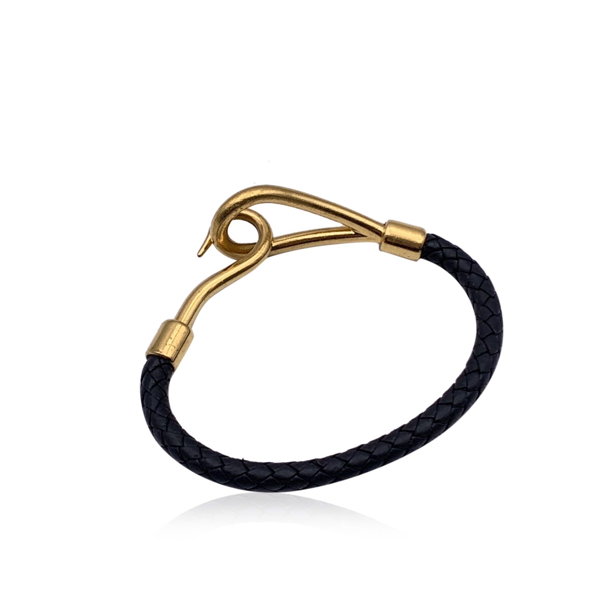Hermes 'Jumbo Hook' Single Bracelet. Black woven leather string with gold metal hook closure. Long Approx.6.75 inches - 17.2 cm including hook. Hermes logo on hook. Condition B - VERY GOOD Gently used. Minimal wear of use on the hardware. Please,